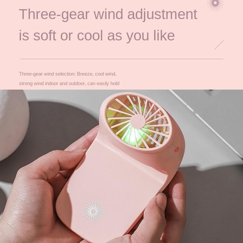 White multi-function fan detached from its base, highlighting its travel-friendly design.