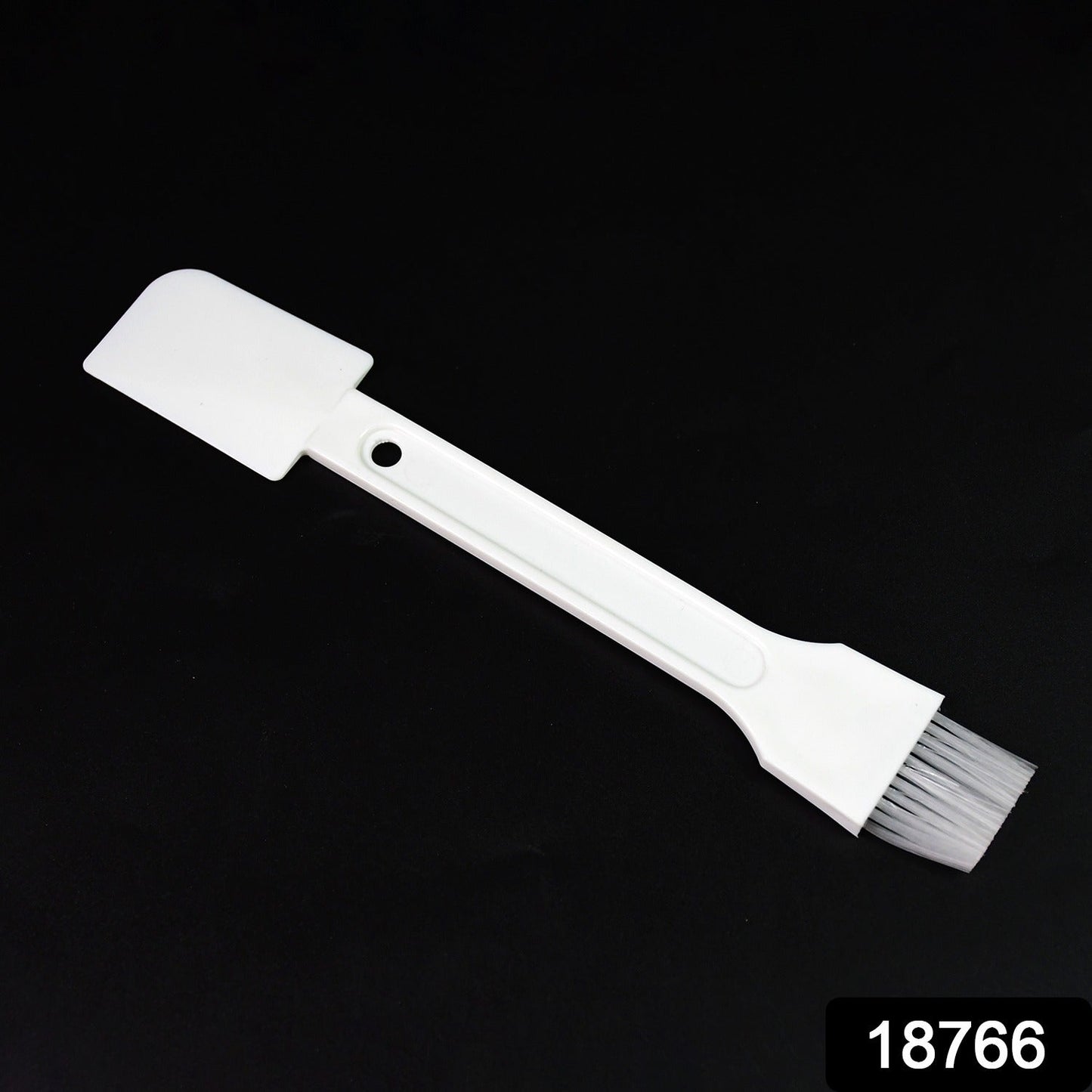 Small dust cleaning brush effectively cleaning keyboard keys.