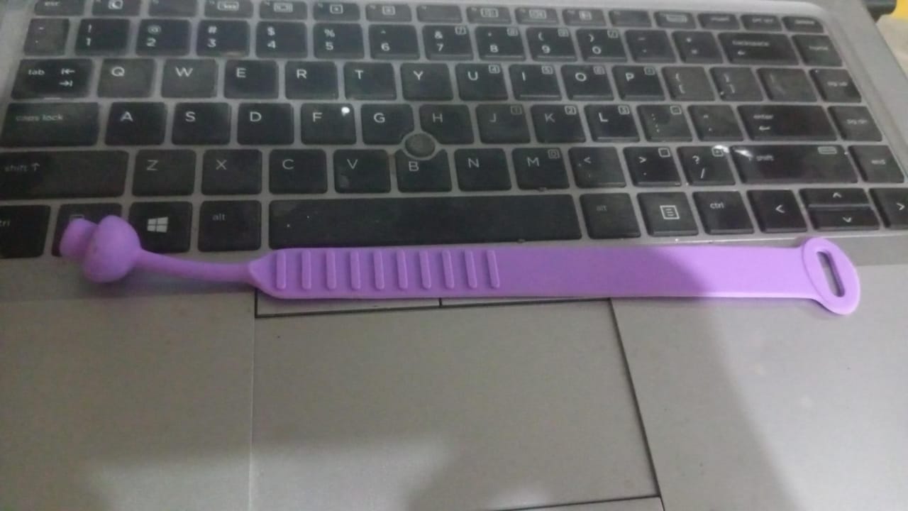The hygienic silicone toilet seat lifter band on a sleek white toilet.