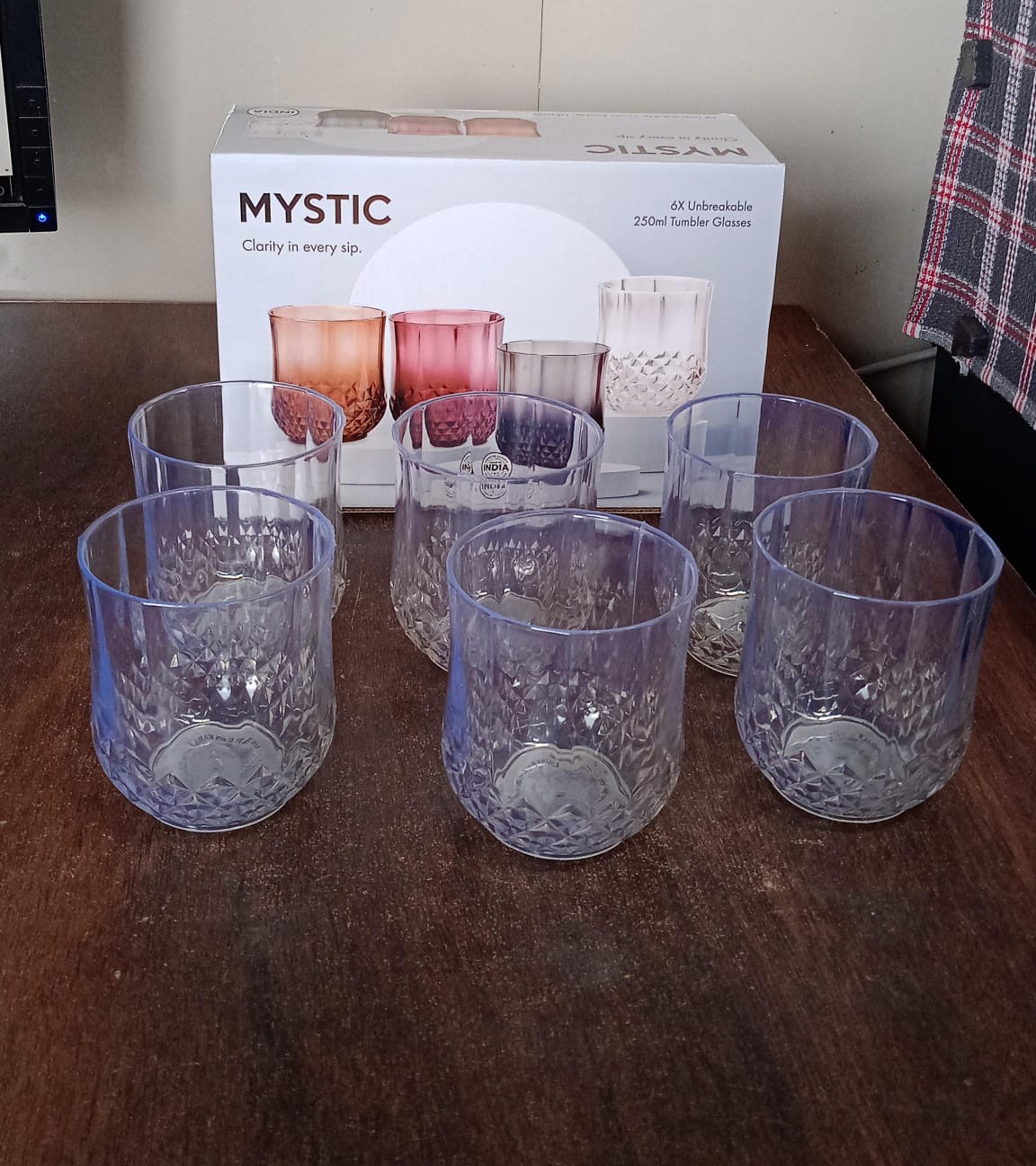 Fully transparent heavy-duty plastic glasses in a modern kitchen setting.