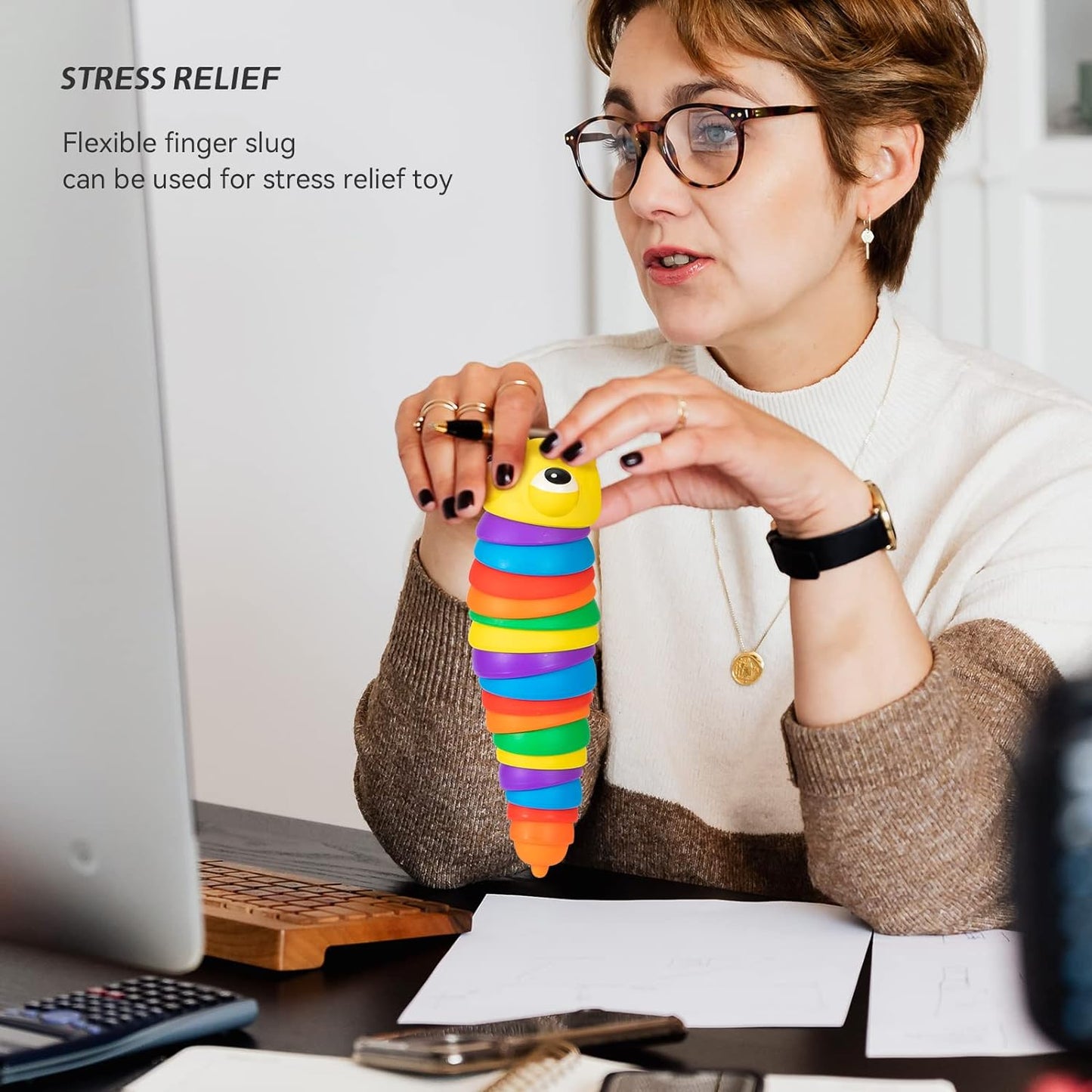 Stress-relieving rainbow plastic slug fidget toy curled into a compact, engaging shape.
