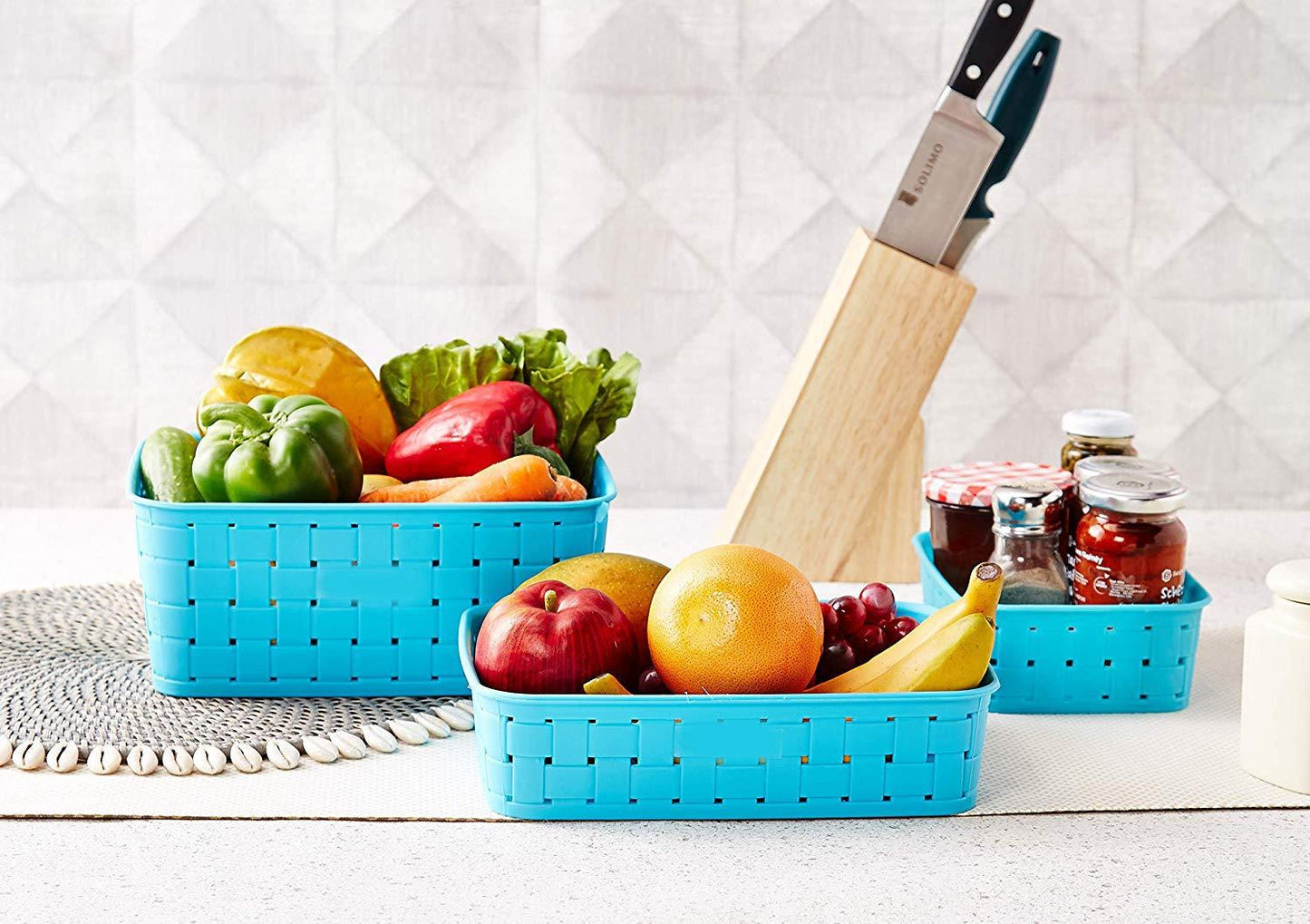 Set of three sky blue storage baskets, perfect for kitchen organization.