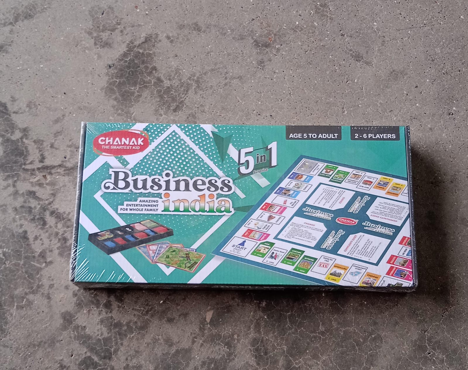 Close-up of plastic money, game board, and pieces for the business learning game.