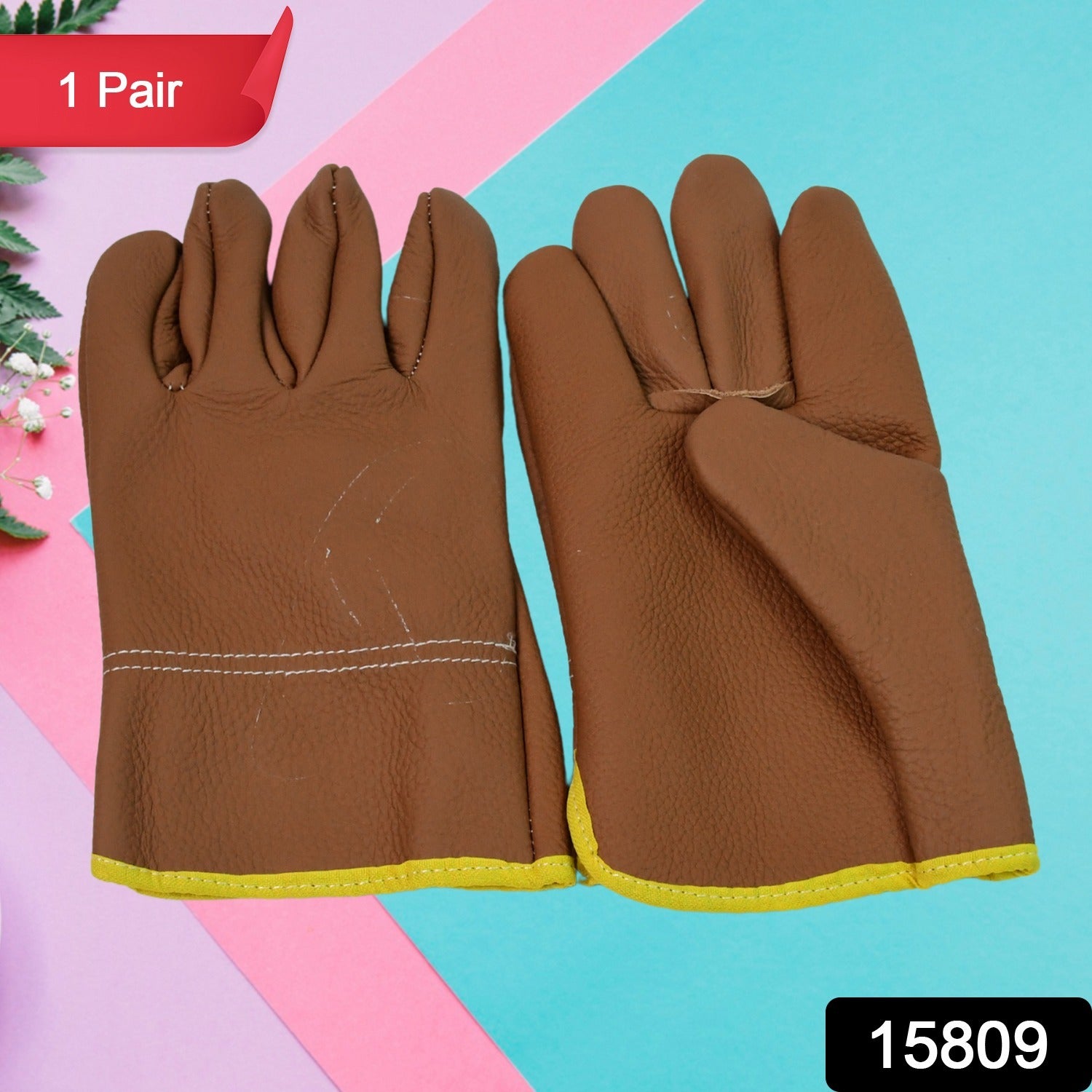 Close-up of leather gardening gloves protecting hands while pruning thorny rose bushes.