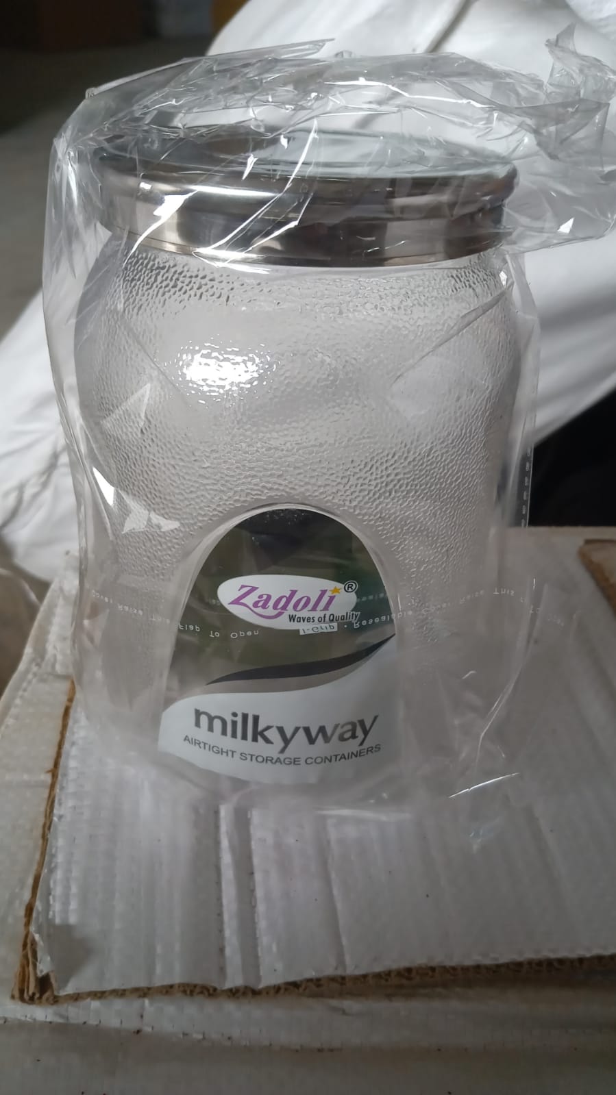 Lifestyle shot of an airtight plastic food storage jar in a modern kitchen setting.