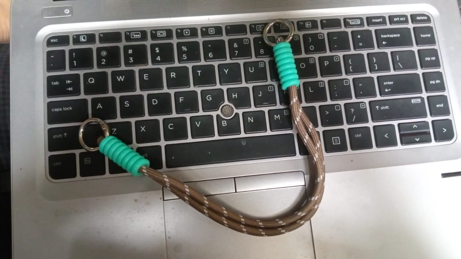 A lifestyle image of a person enjoying hands-free convenience with a phone wrist strap attached to their device.