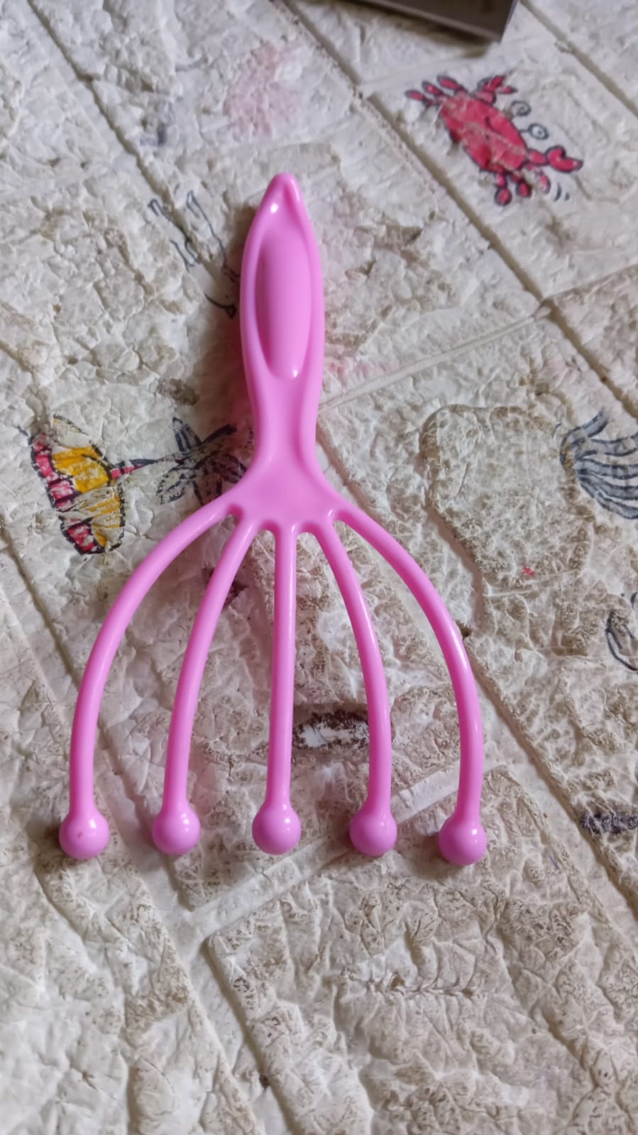 AuriGlam handheld scalp massager shown in its retail packaging.