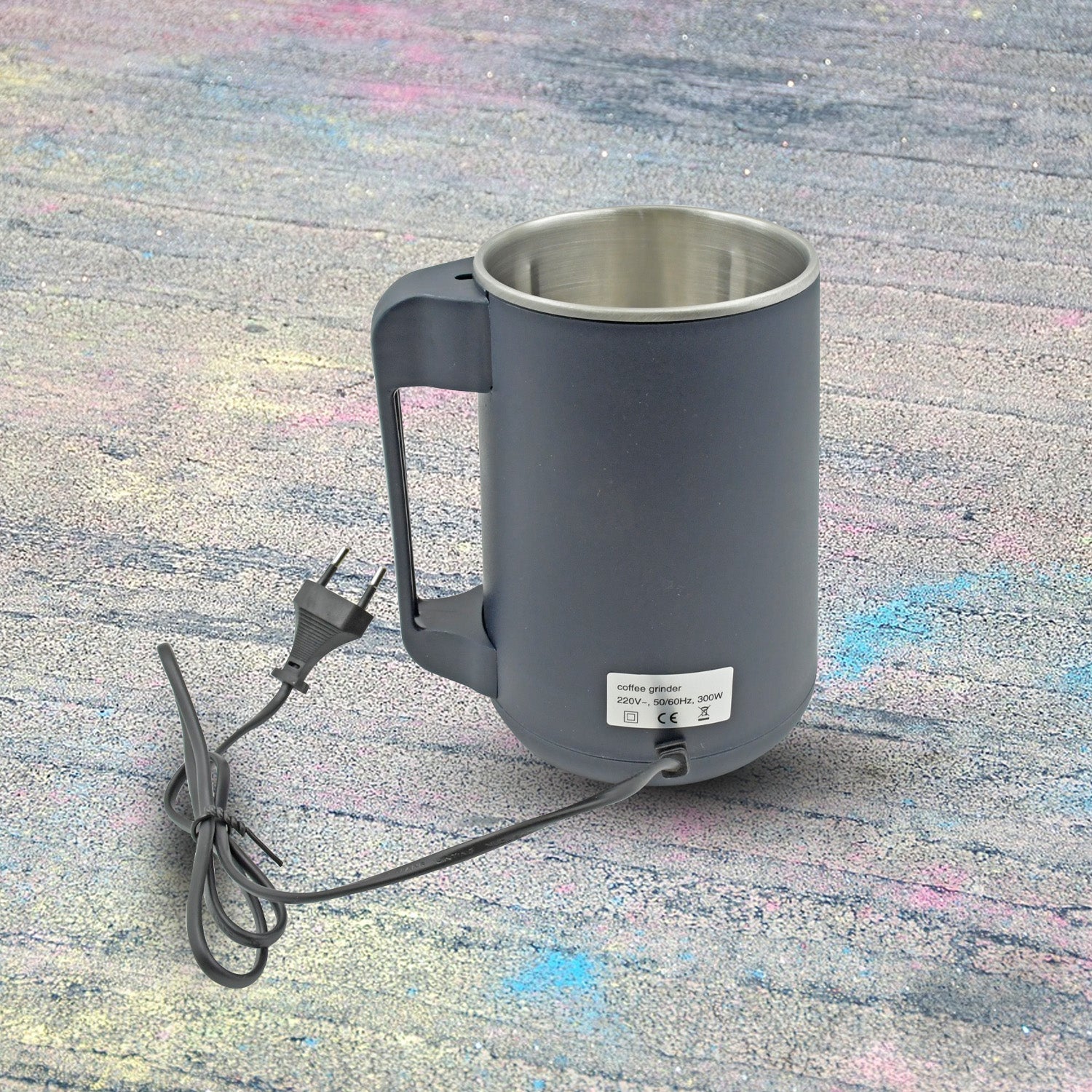 Hand pressing the one-touch button for easy operation of the home electric grinder.