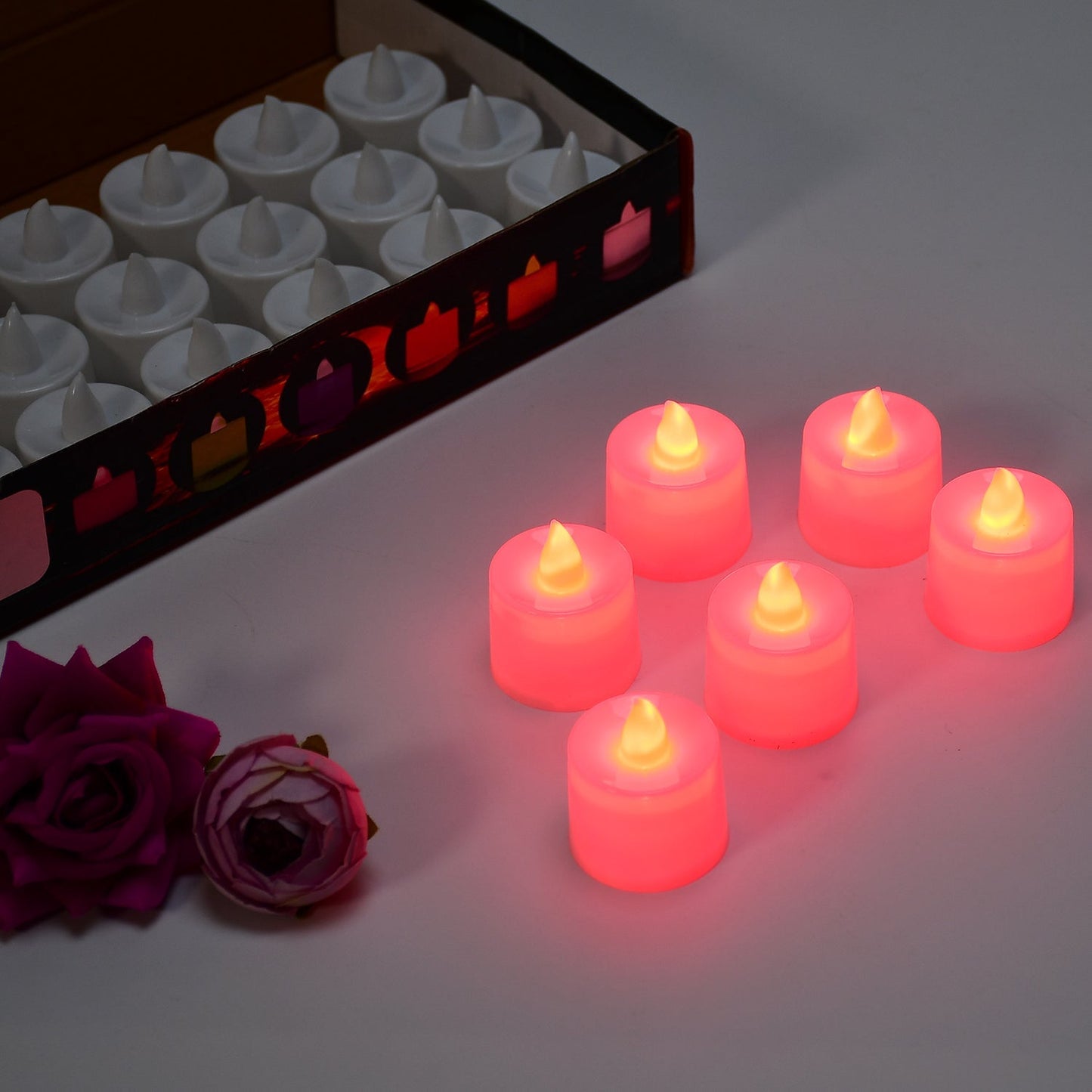Red LED flameless tealight candles creating warm ambient light at a party setting