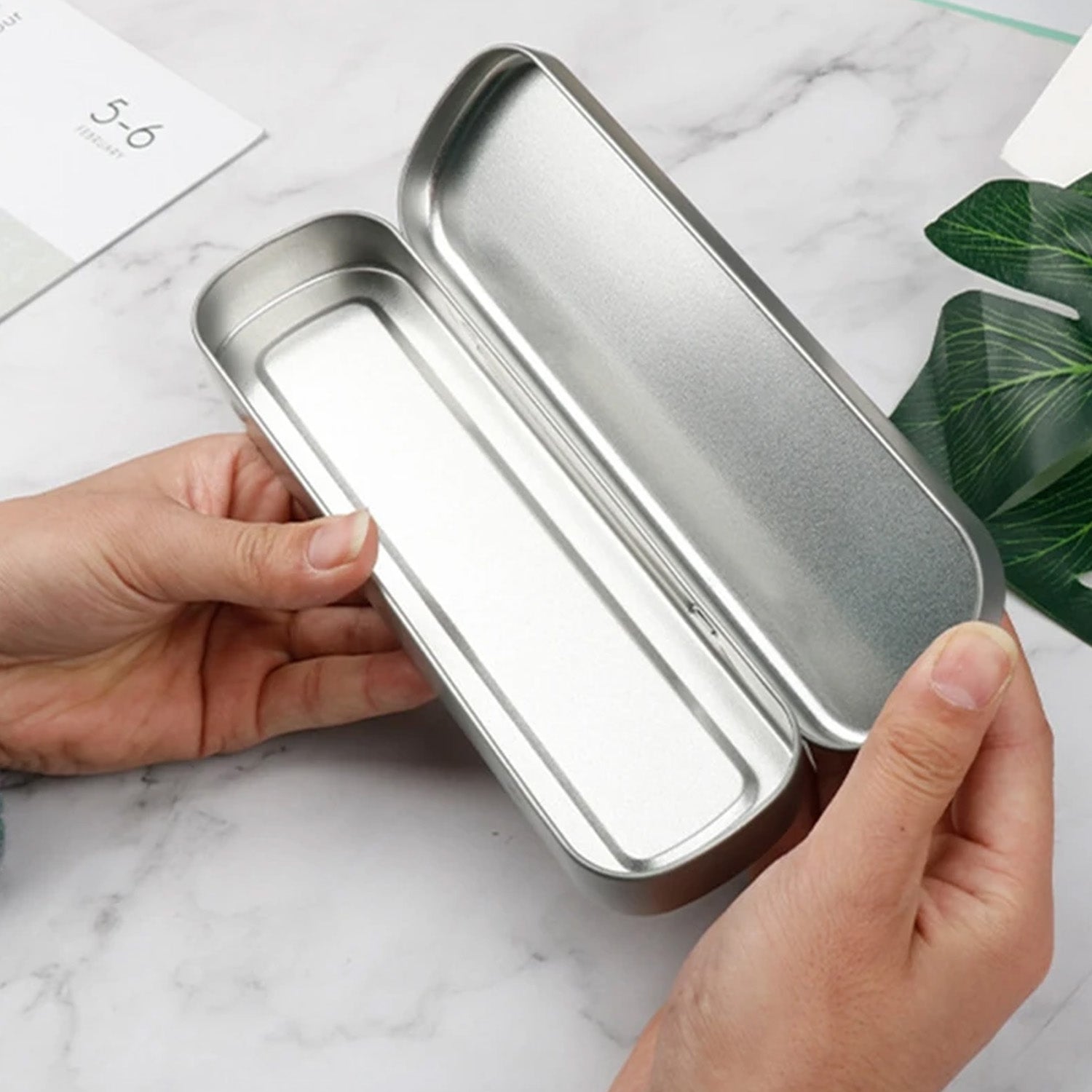 Ergonomic stainless steel tongue scraper for effective oral cleaning.