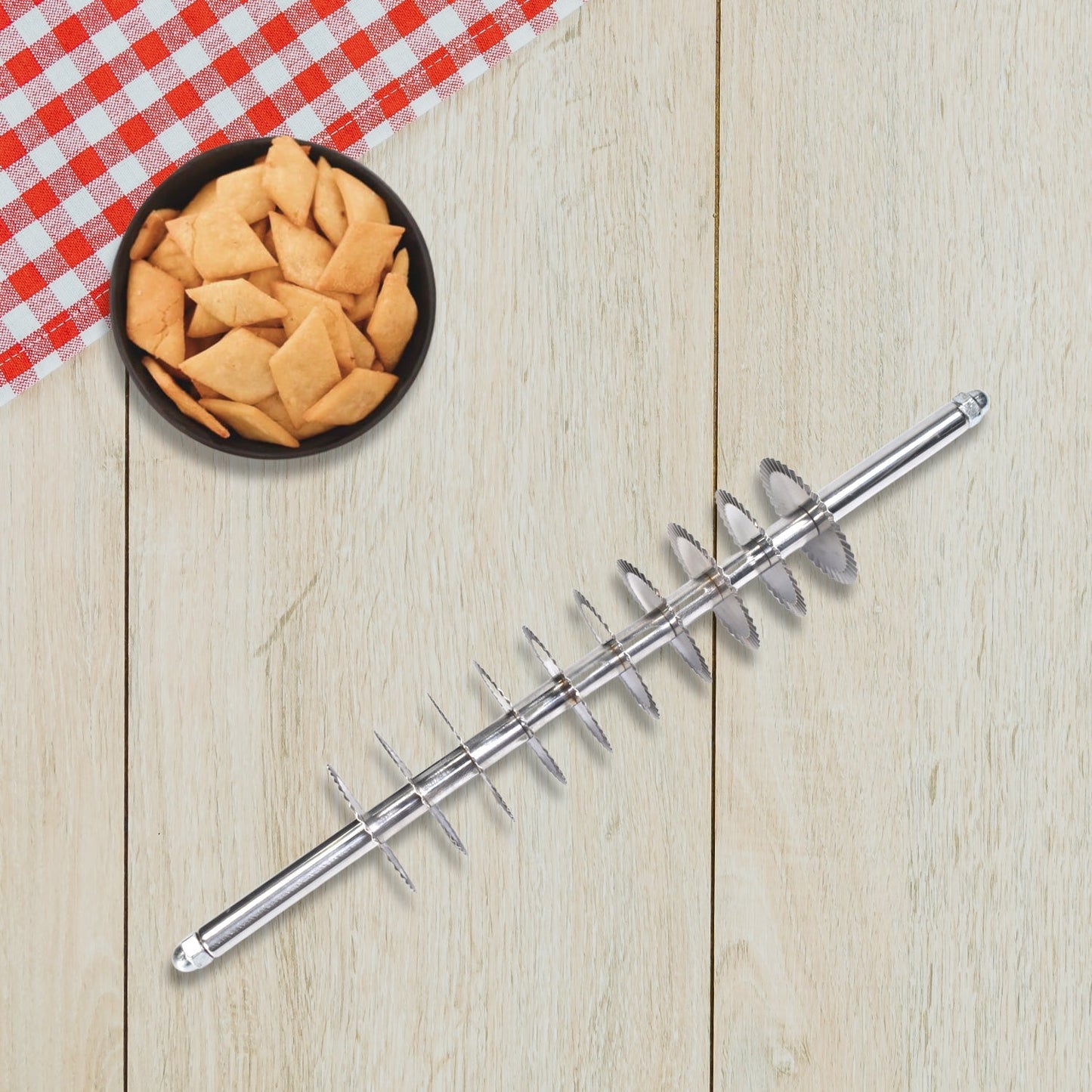 Stainless steel dough cutter with multiple wheels for uniform noodle and pastry cuts.