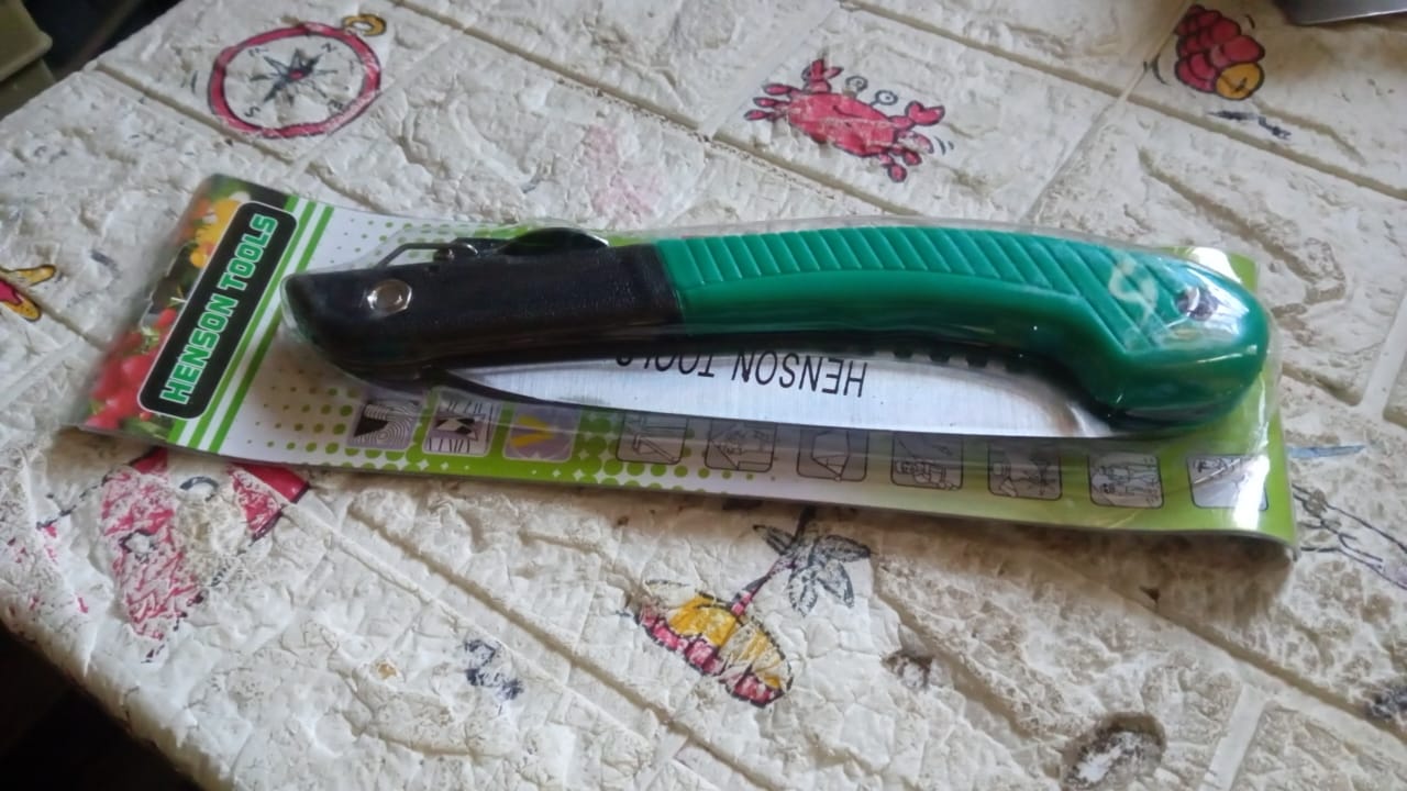 Multi-purpose folding handsaw demonstrating its capability for diverse cutting applications.