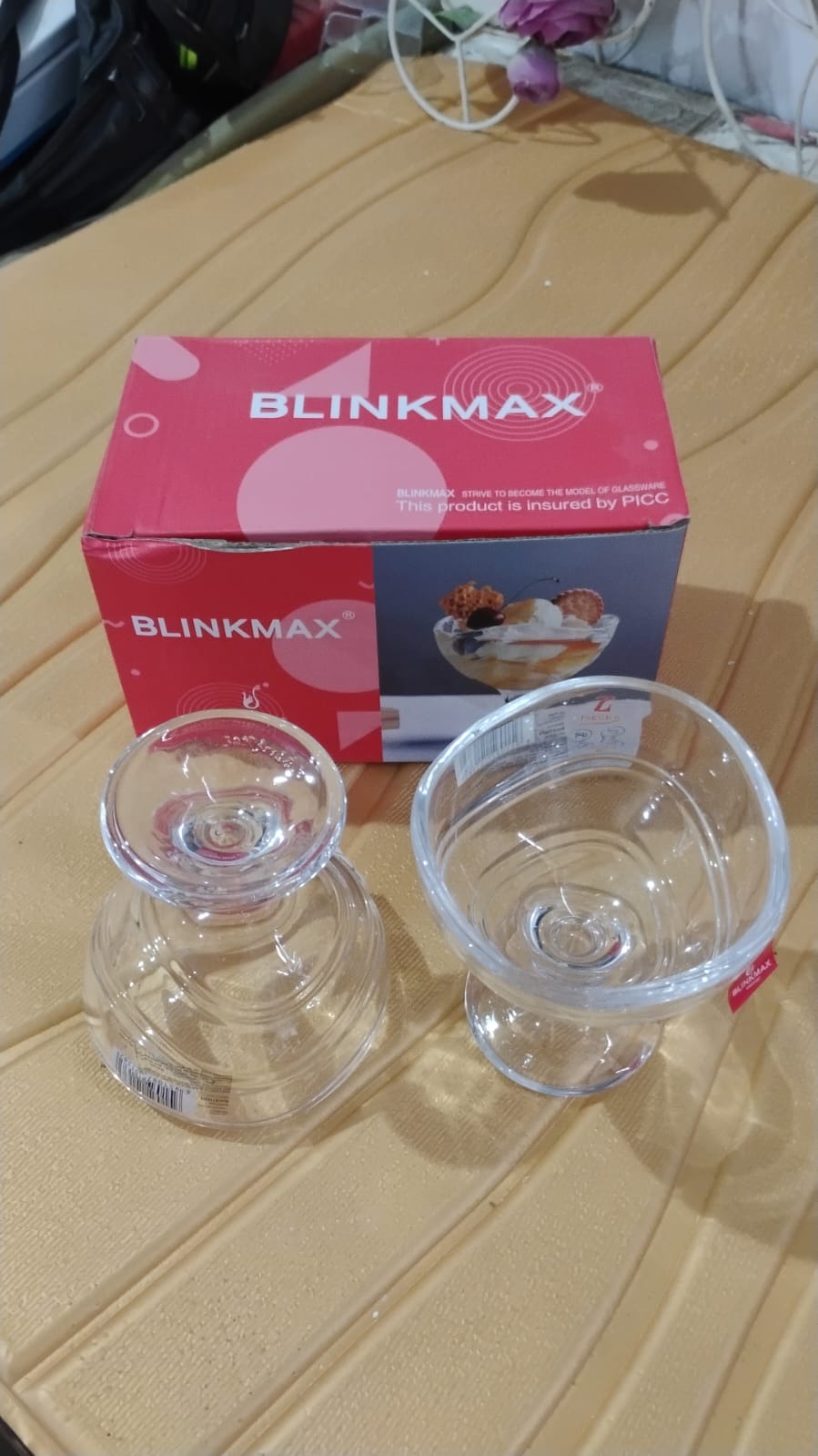 Pair of elegant glass dessert bowls displayed together on a table.