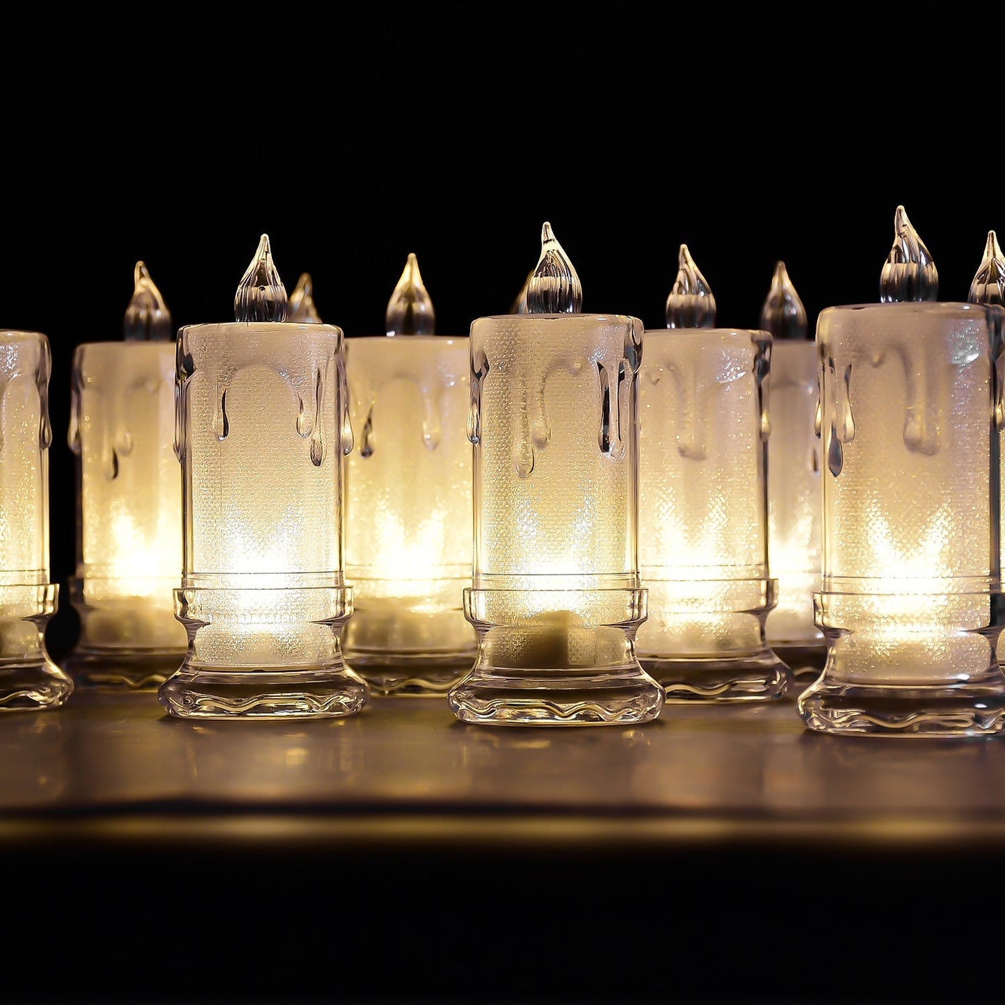 A charming group of Melted Design Flameless Candles casting a warm, inviting glow in a room setting.