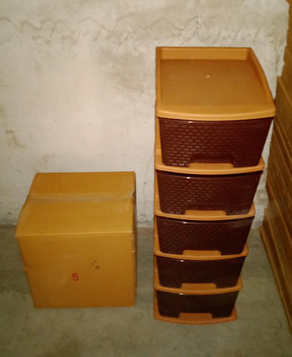 Full view of the brown 5-tier plastic modular drawer system against a plain background.