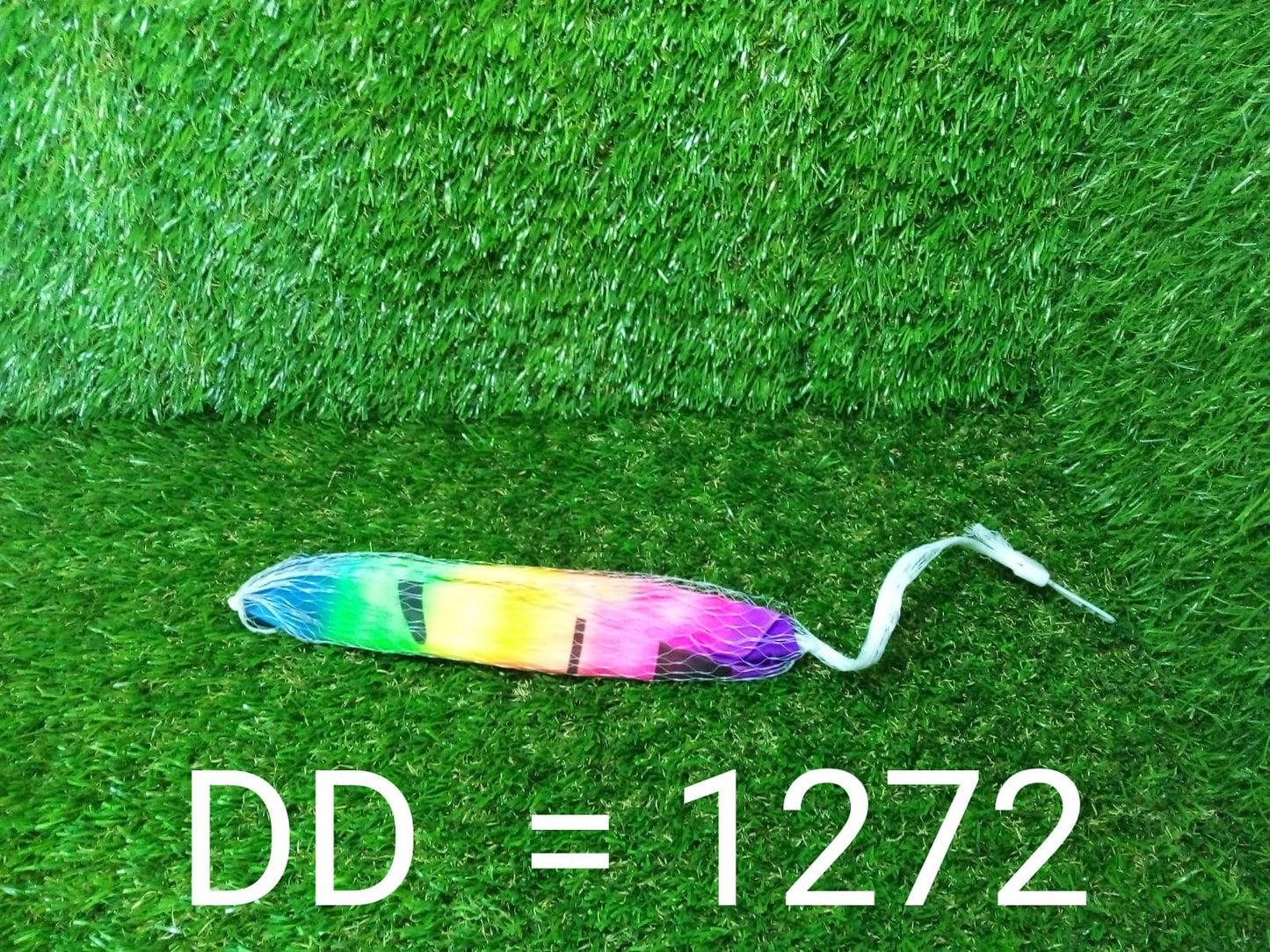 Happy child smiling while holding a soft Kids Beach Ball by the water.