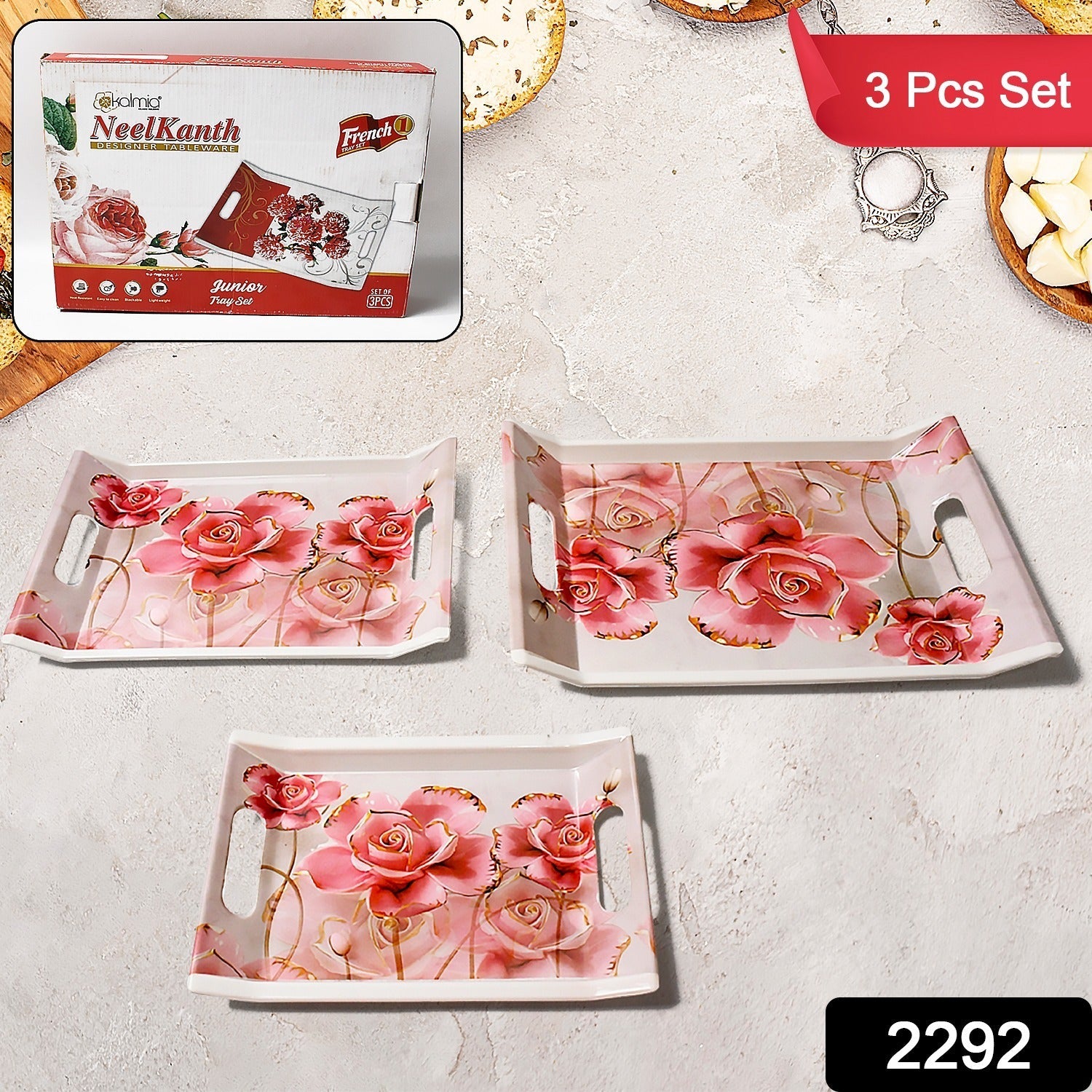 Three rectangular plastic serving trays of varying sizes on a countertop.