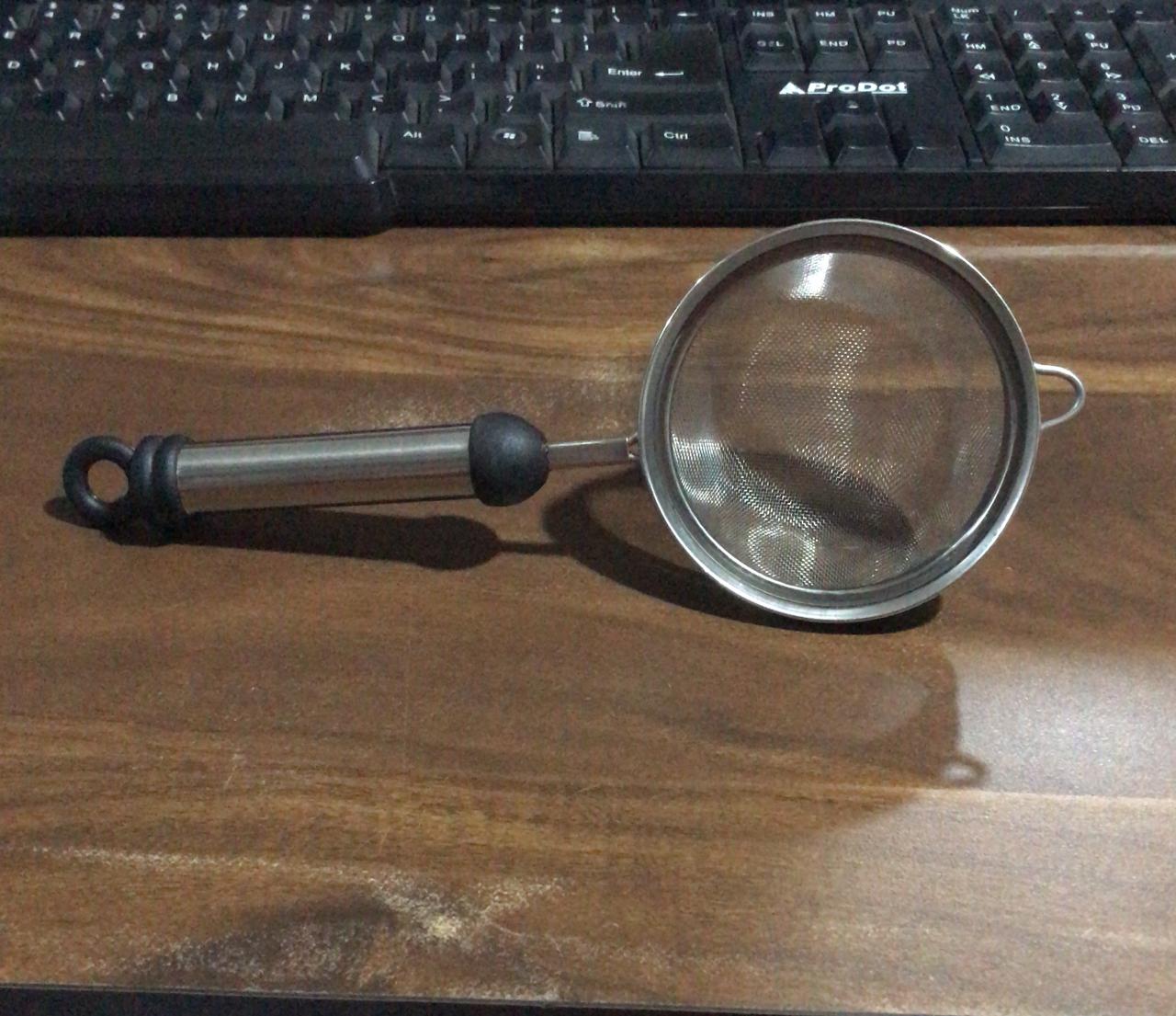 Rust-resistant stainless steel strainer with fine mesh for soups and juices.