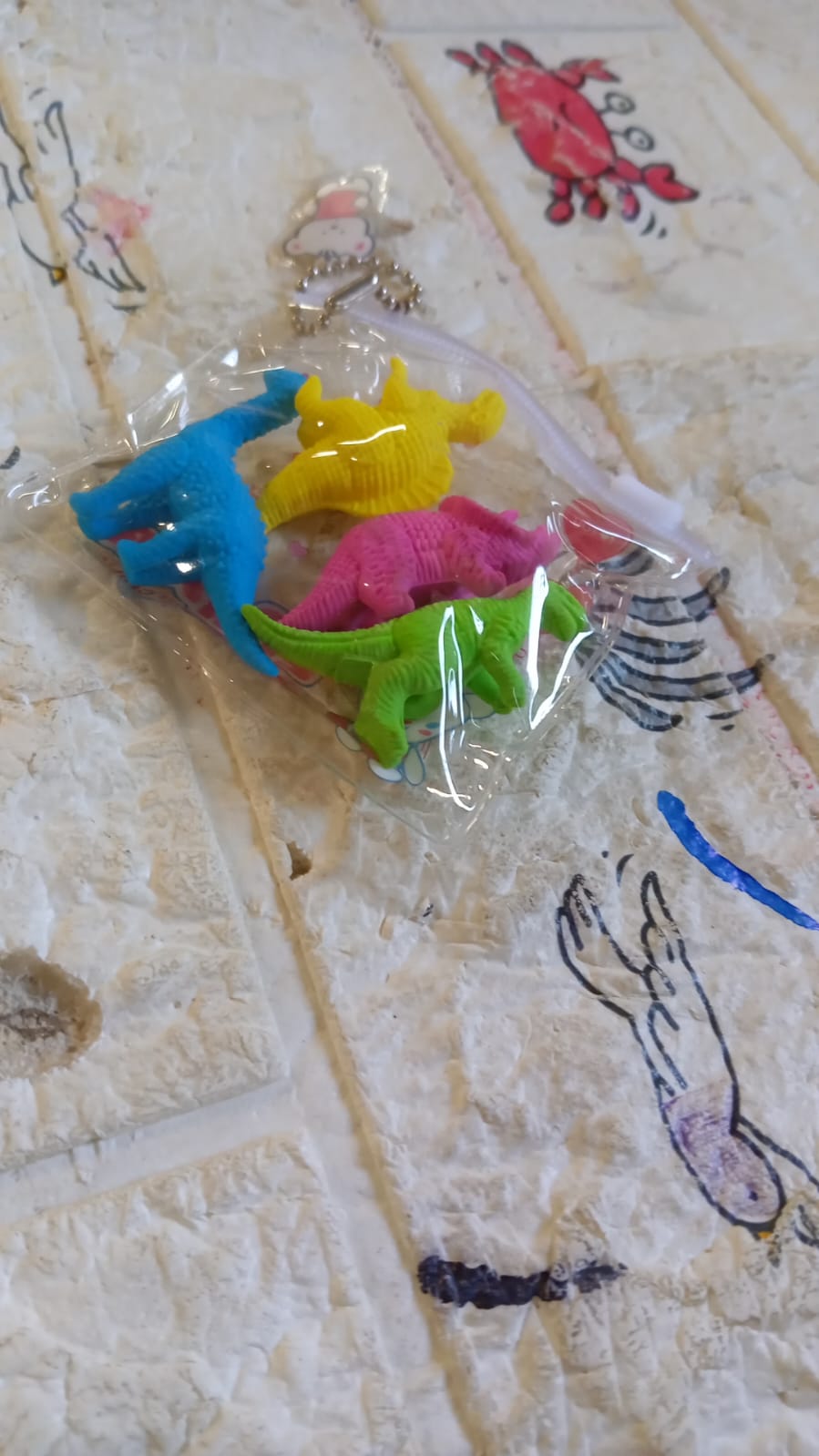 A complete set of four non-toxic dinosaur erasers, essential fun stationery for kids.