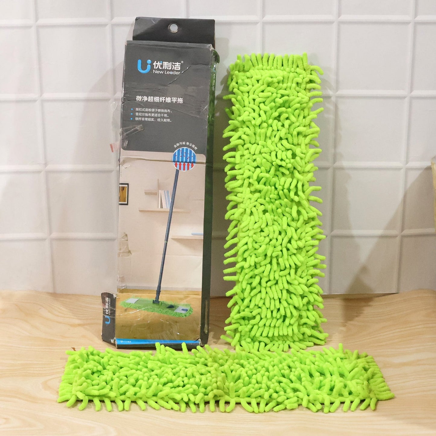 Microfiber mop shown with hand for scale, highlighting its comfortable grip.