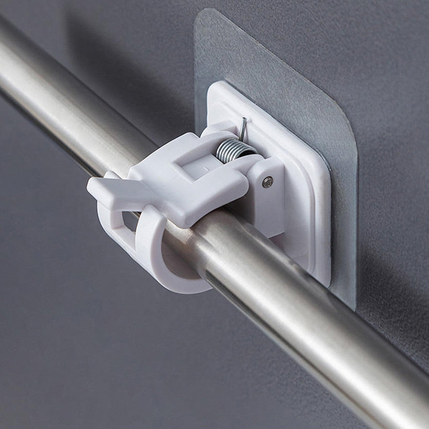 Close-up of wall-mounted adhesive towel rod holder with hanging towels