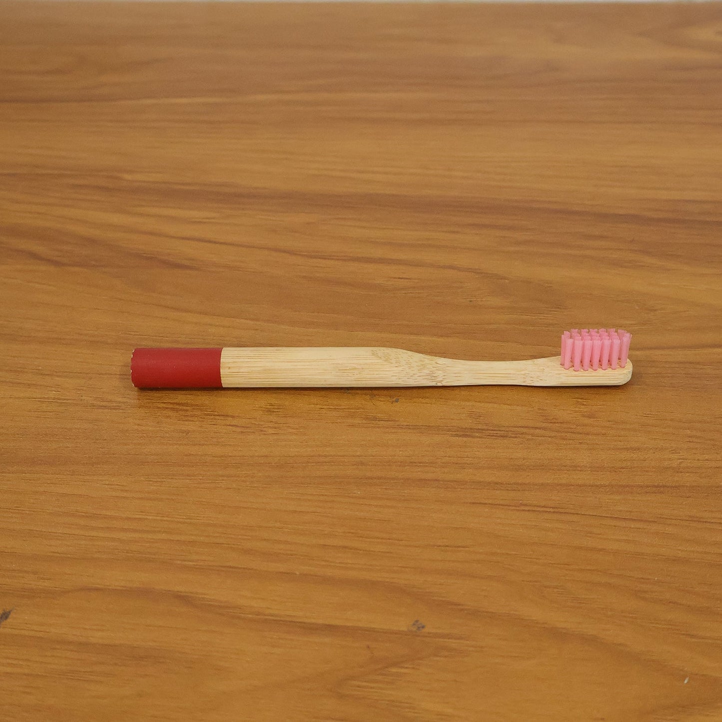 Lifestyle image of bamboo toothbrush in bathroom setting