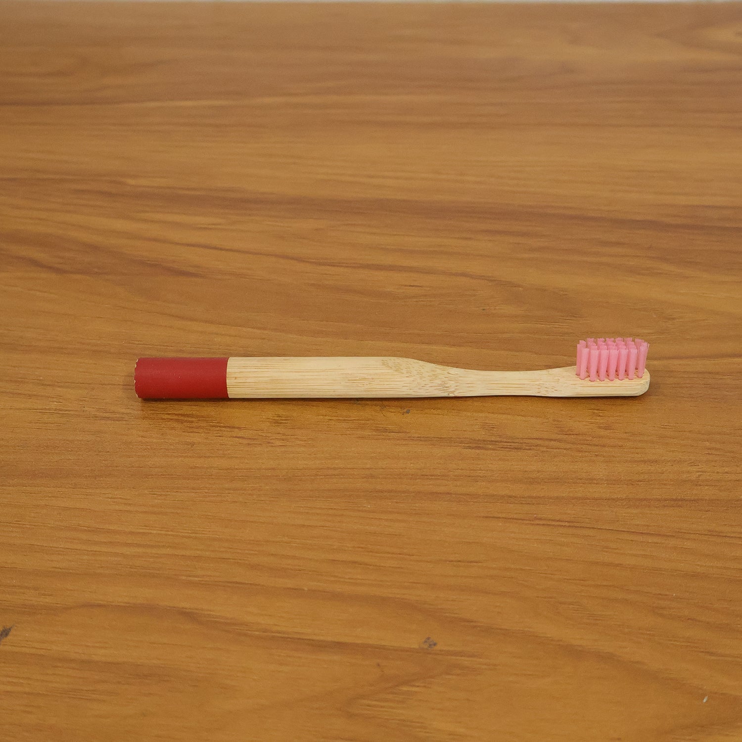 Lifestyle image of bamboo toothbrush in bathroom setting