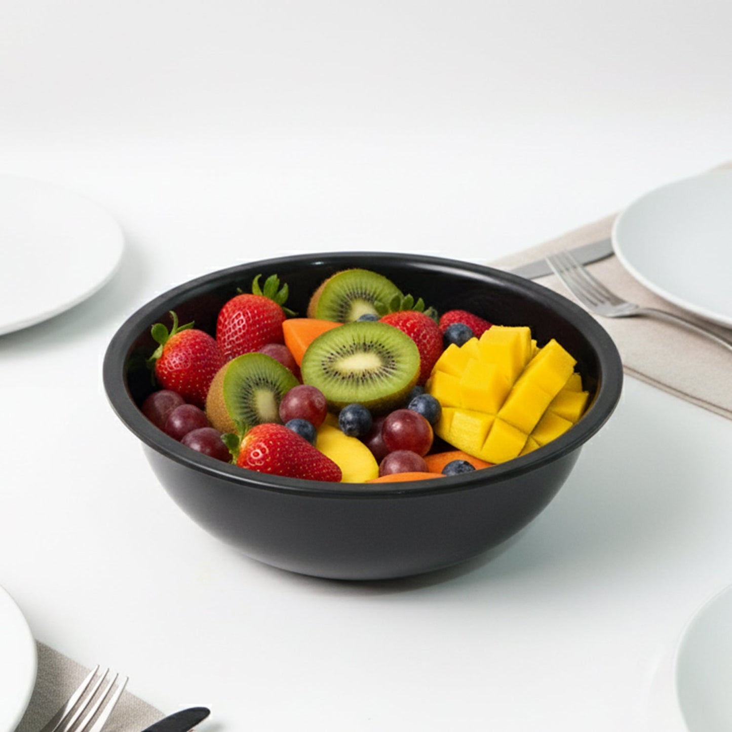Empty 6-inch black plastic serving bowl angled view