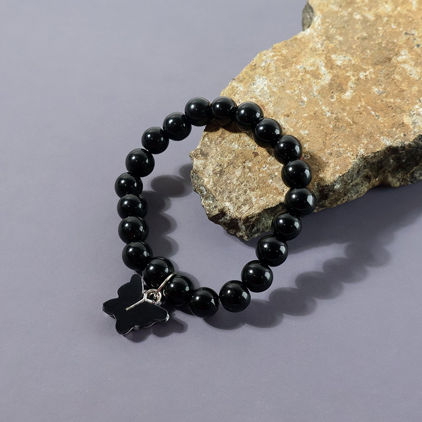 Side view of bracelet showing butterfly charm and beads