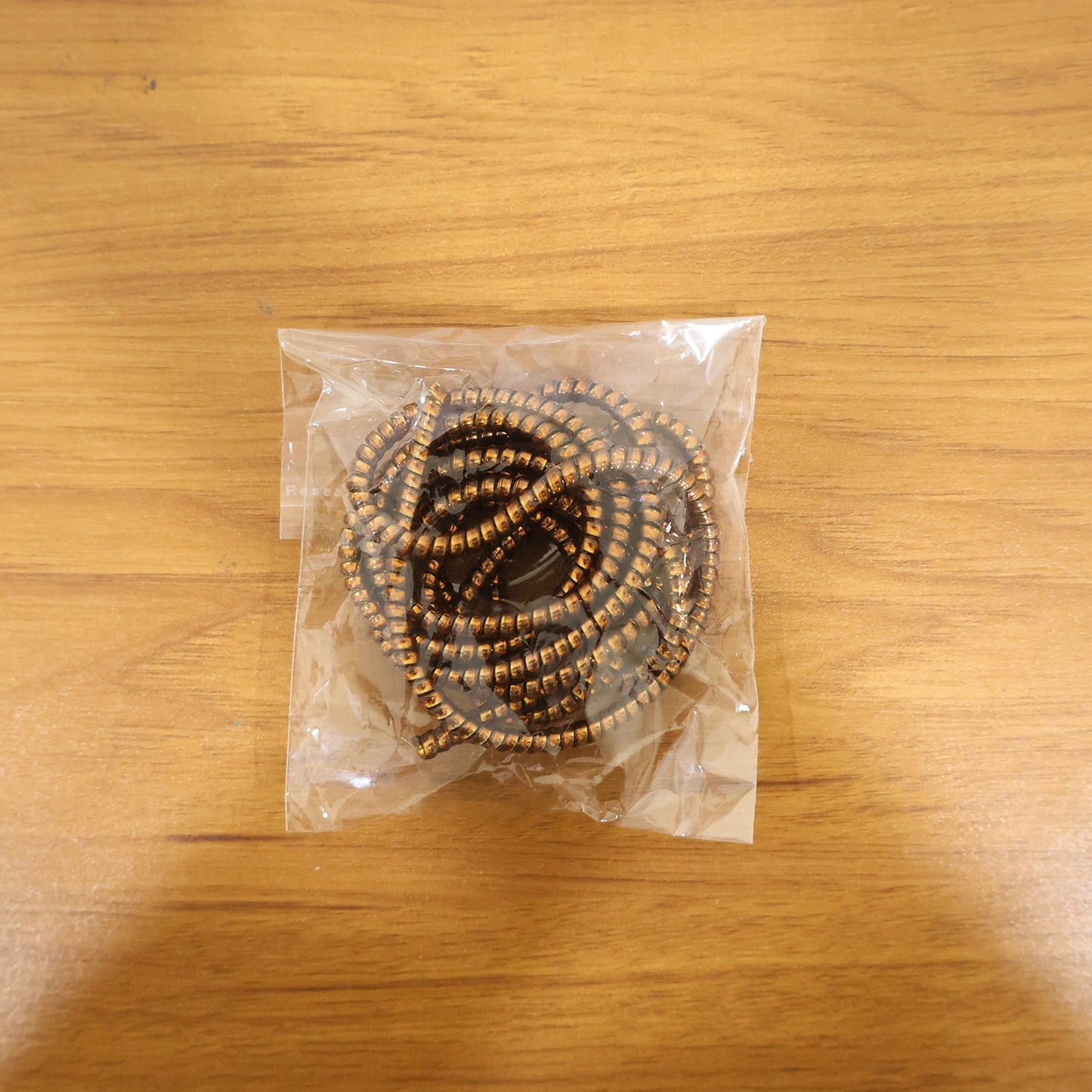 Brown spiral cable protector sleeve shown protecting charging cable live