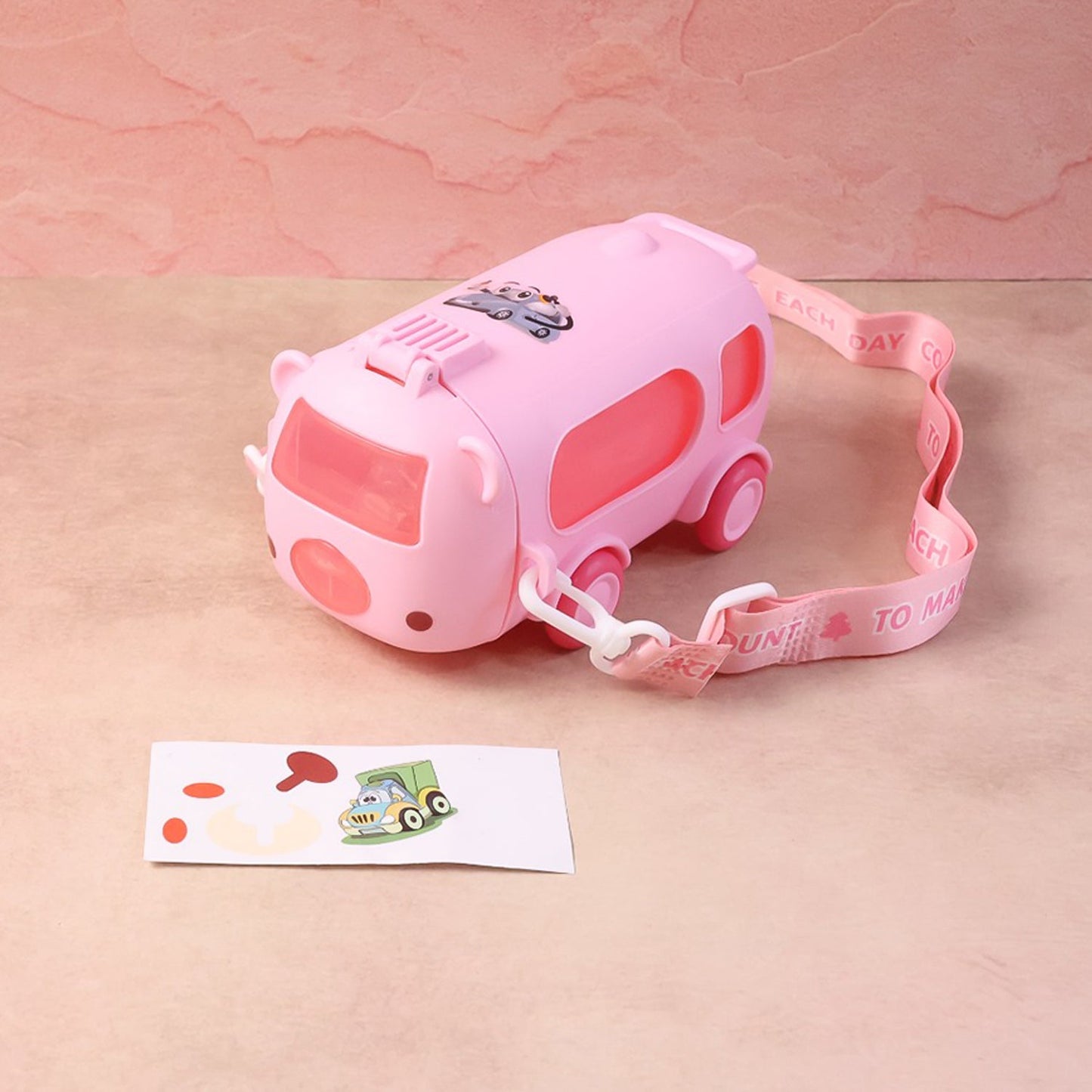 Side profile of bus shaped water bottle designed for children with strap