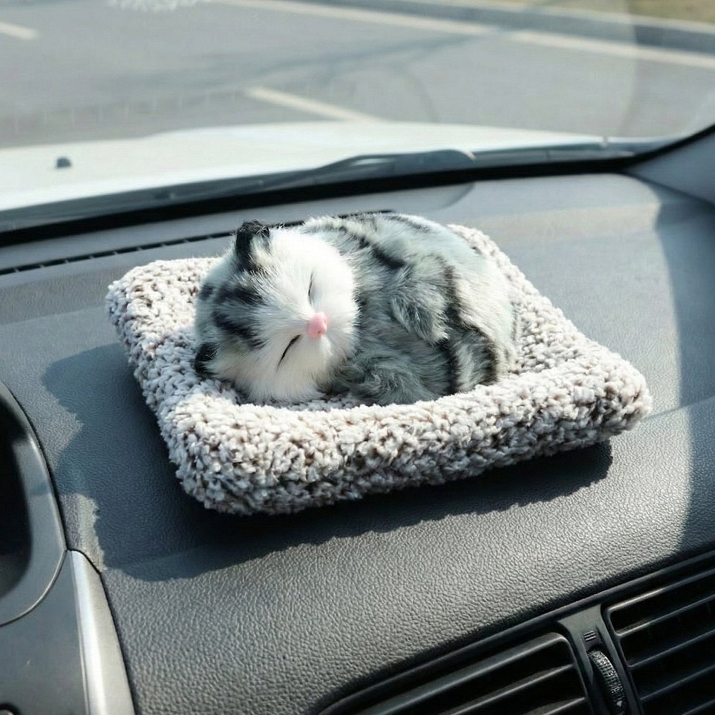 Adorable plush cat car ornament with a soft finish and closed eyes