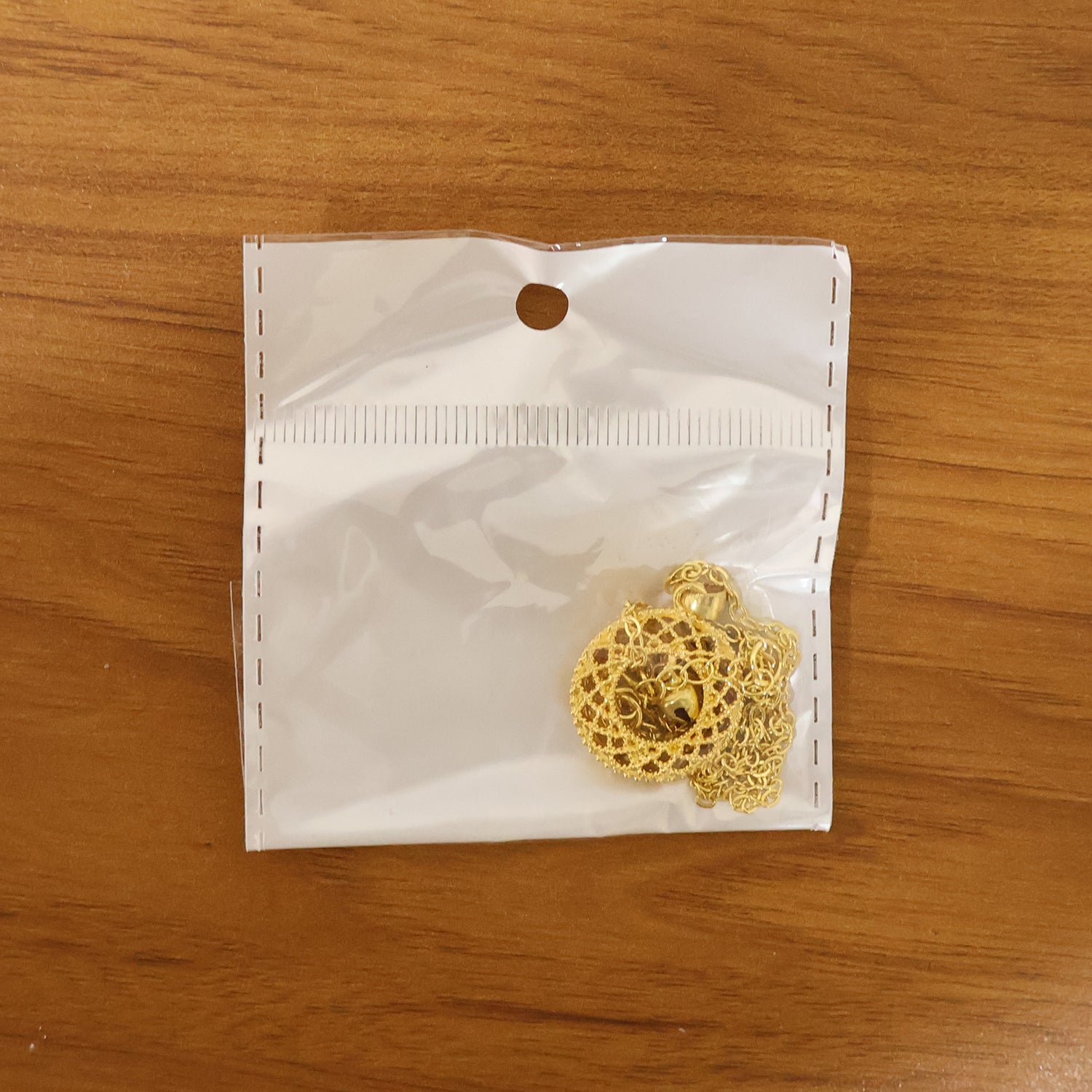 golden pendant with intricate patterns highlighting elegant design