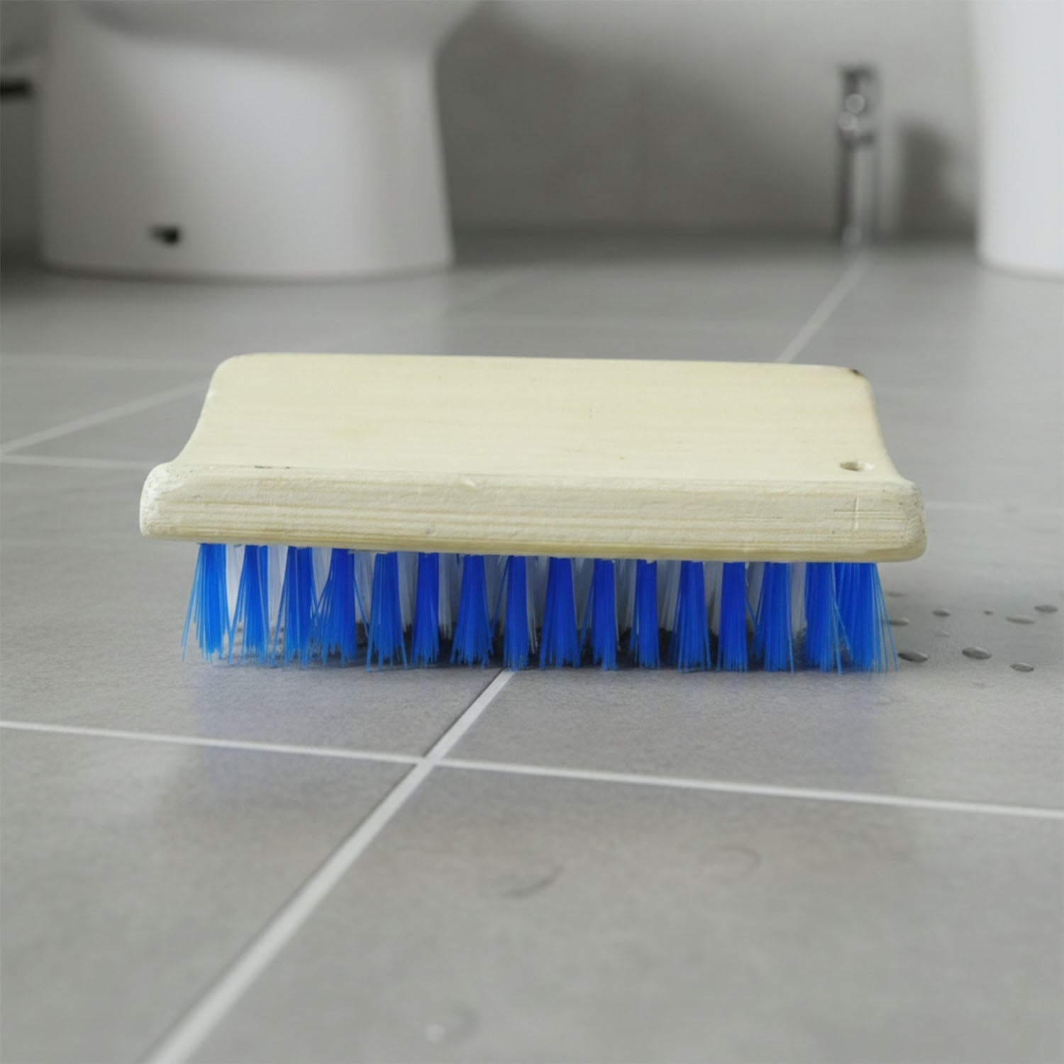 Hard bristle cleaning brush designed for tough stains on floors and clothing