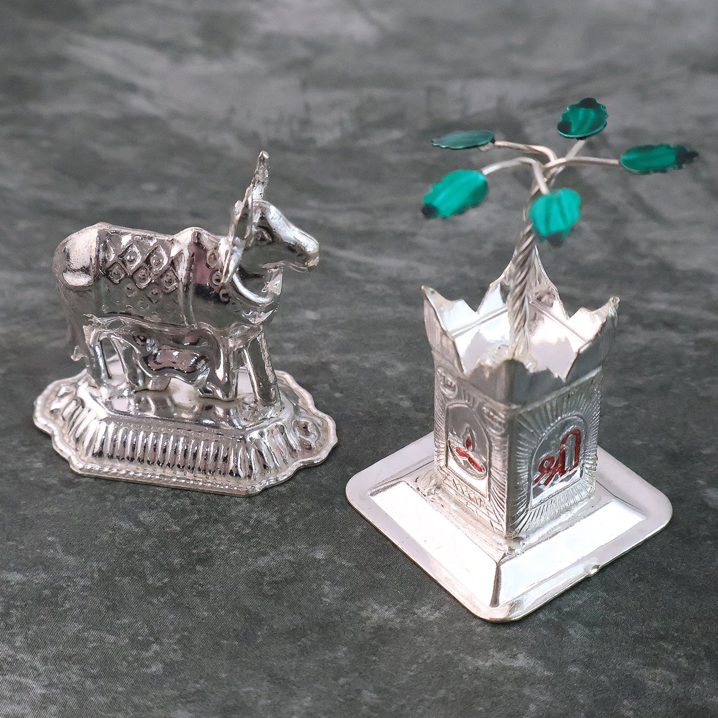 Detailed silver-plated Kamdhenu cow and Tulsi plant pair with Swastik symbol for pooja