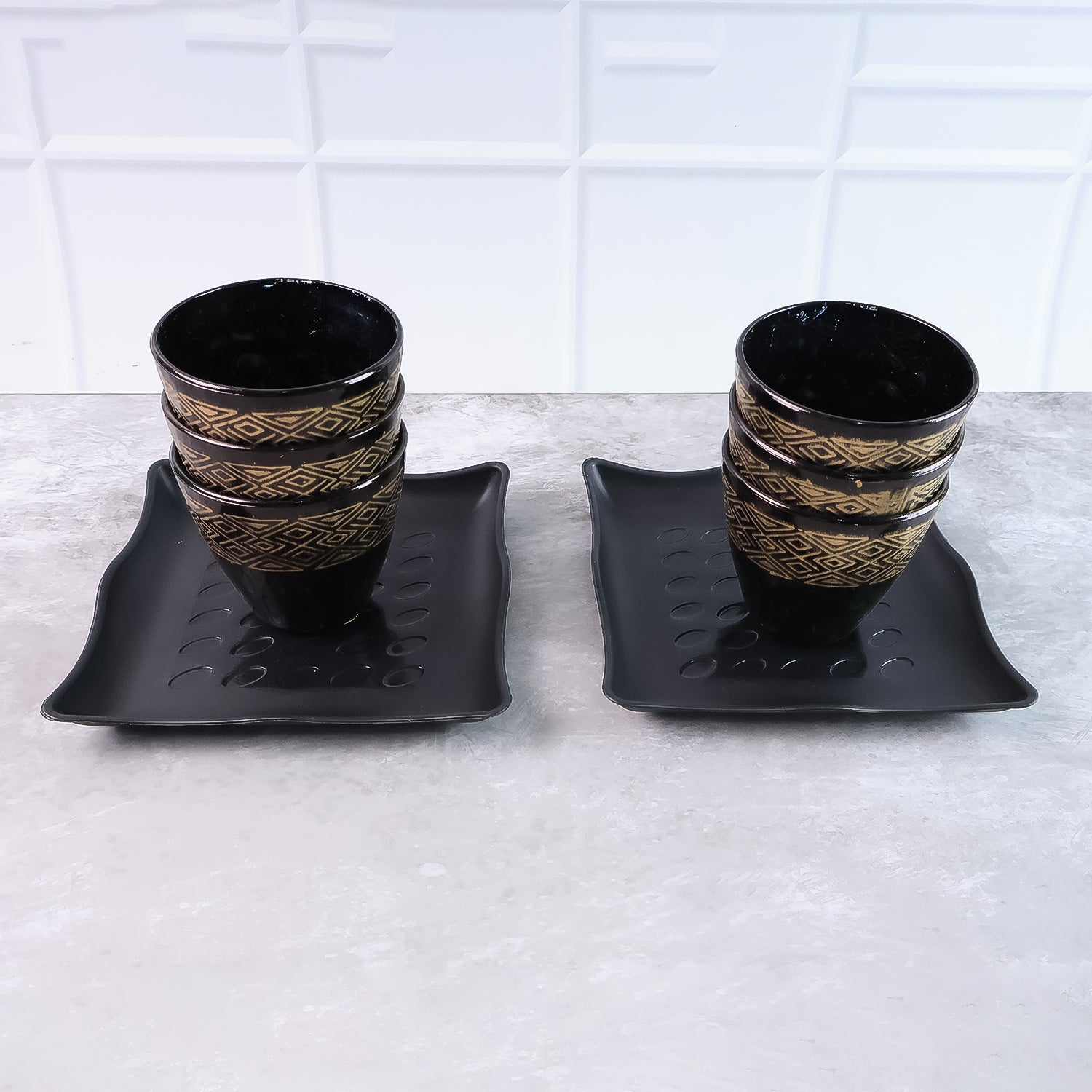 Artfully arranged ceramic dining set with six cups and two bowls, ready for use.
