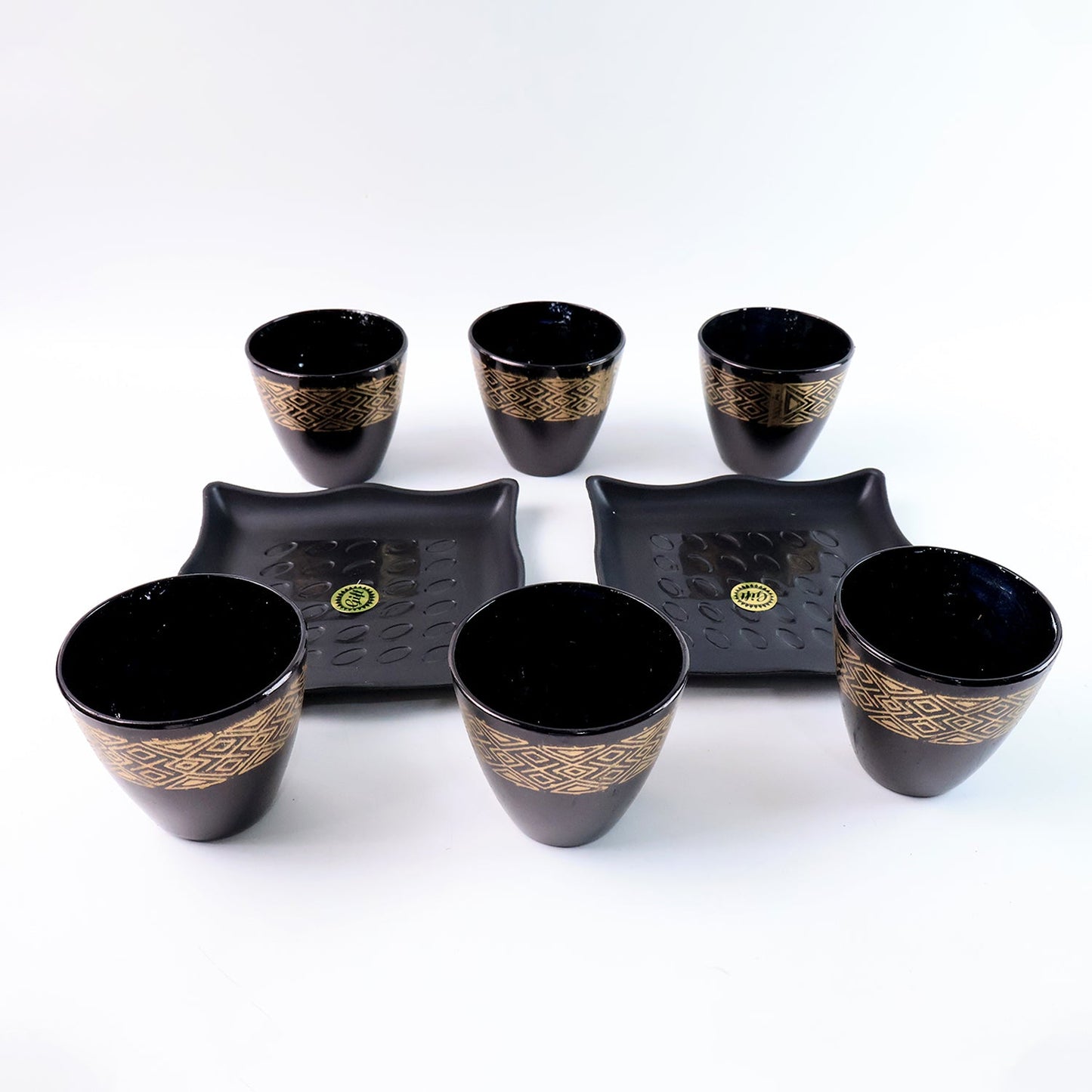 Stack of ceramic bowls and cups from the 8-piece collection by Indo Glow.