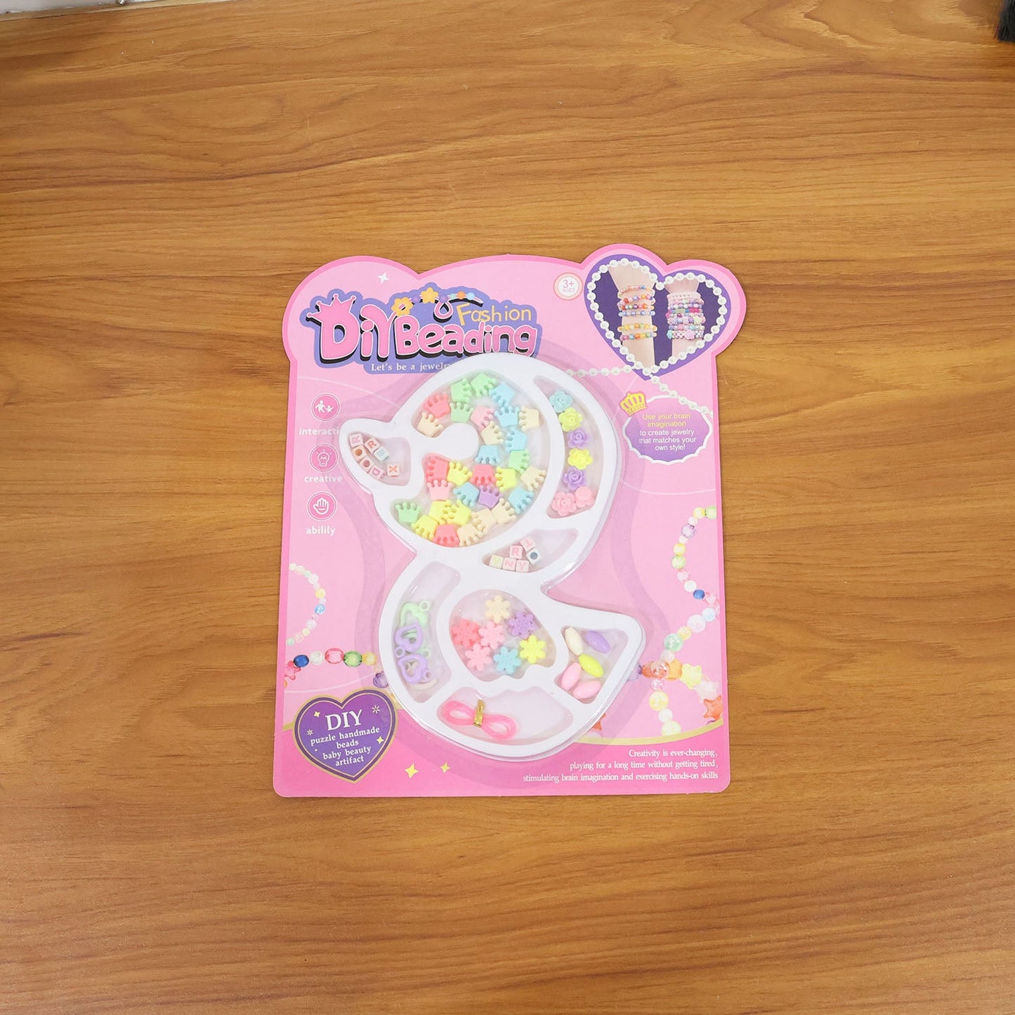 Lifestyle image showing children creating bracelets with DIY jewellery kit