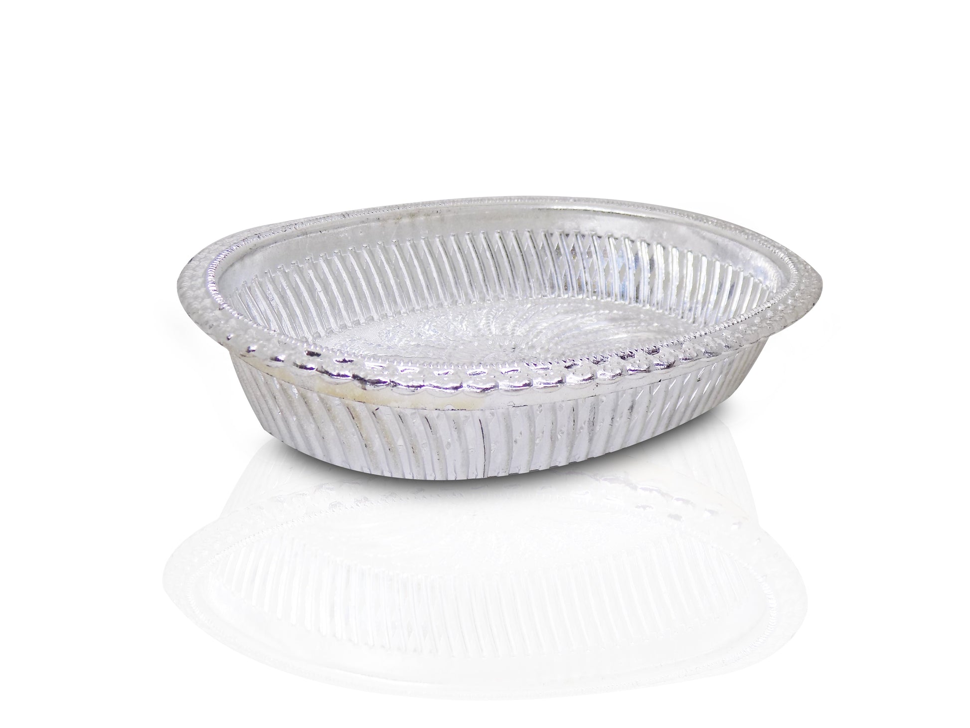 Close-up of a decorative oval silver tray with intricate royal patterns.