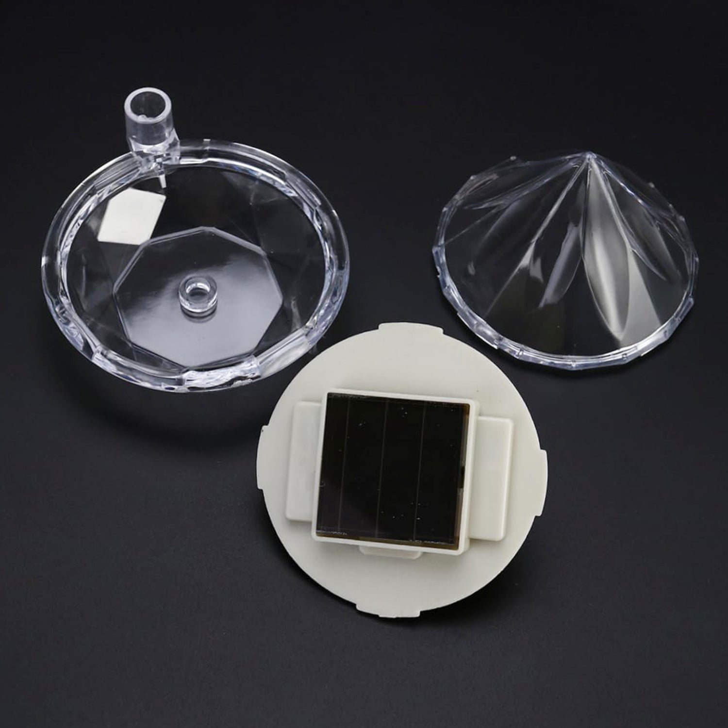 Diamond solar garden lights staked in a lush garden bed with green plants