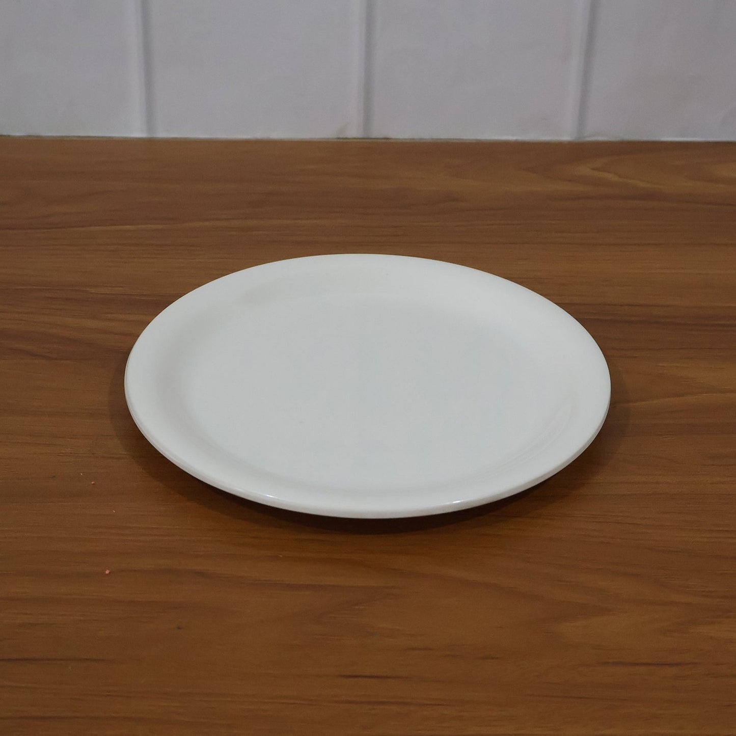 Plastic round dinner plate in use serving Indian meals