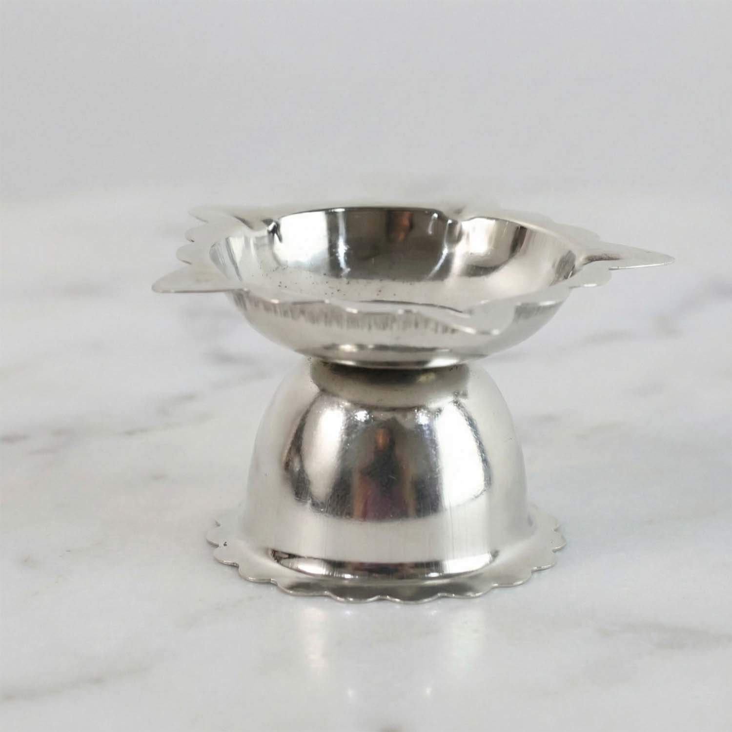 Compact decorative steel diya stand with sunflower design for rituals