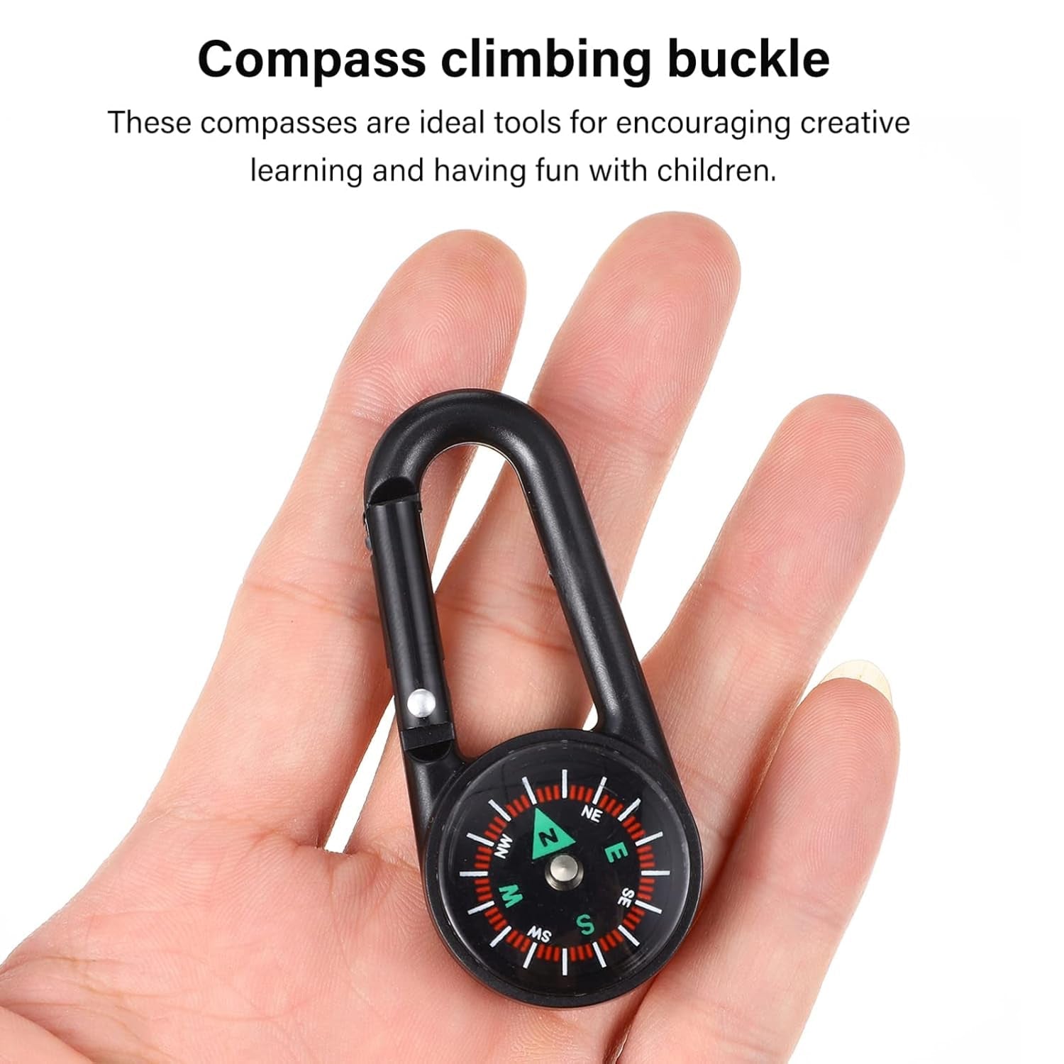 The mini compass with clip held near a map, illustrating its practical application for navigation.