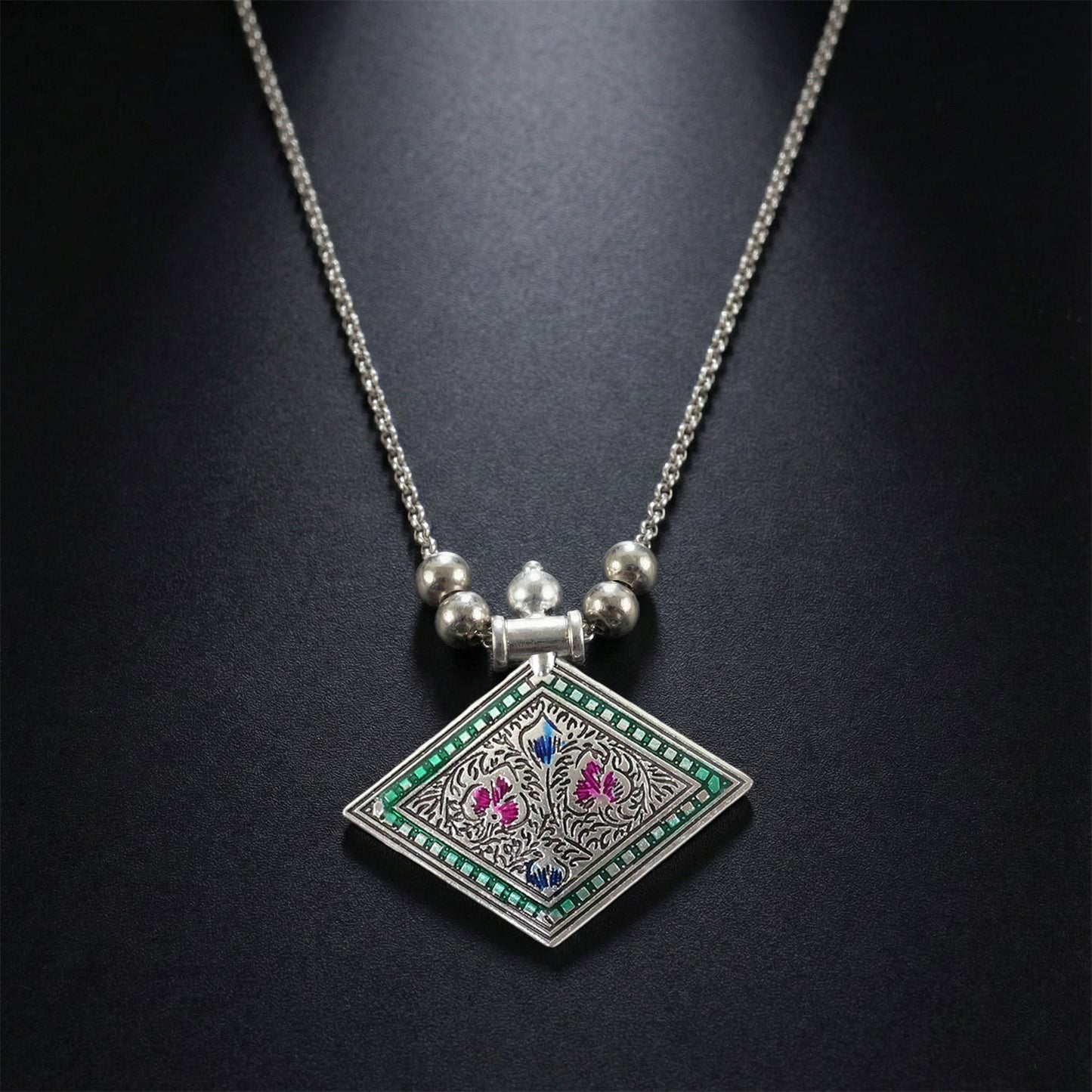 Ethnic oxidised silver finish pendant necklace displayed on white background