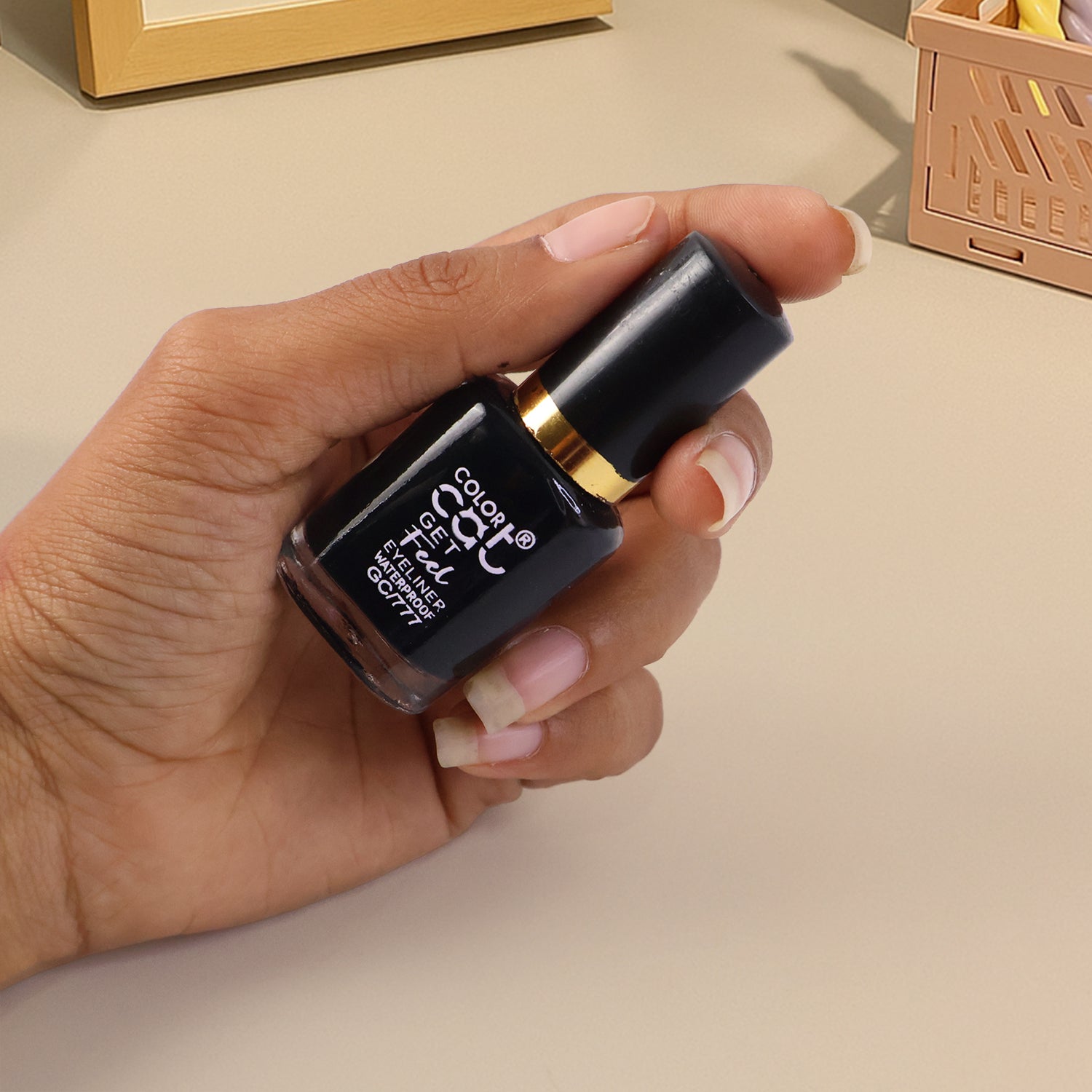 Eye definer using precision-tip waterproof eyeliner for clean lines.