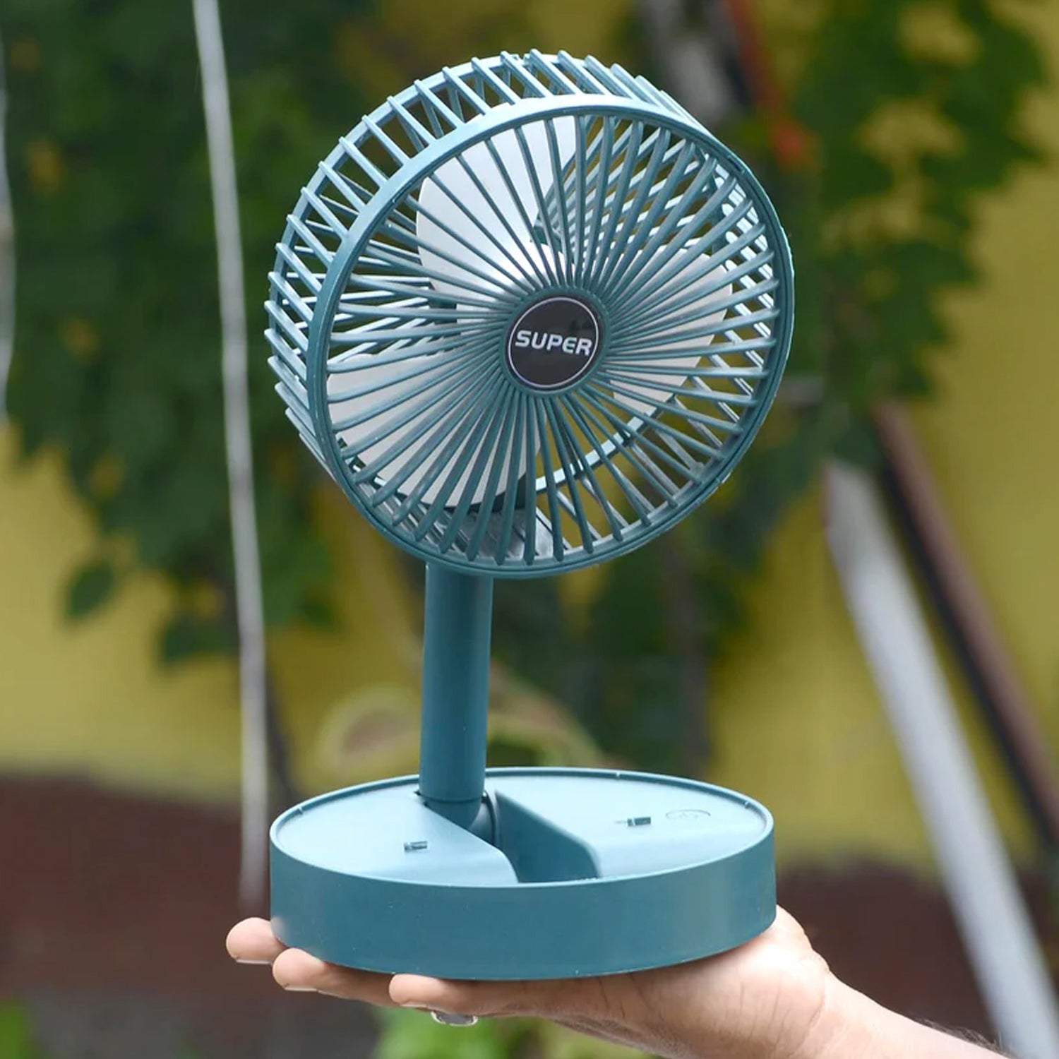 Side angle of foldable mini desk fan highlighting adjustable height