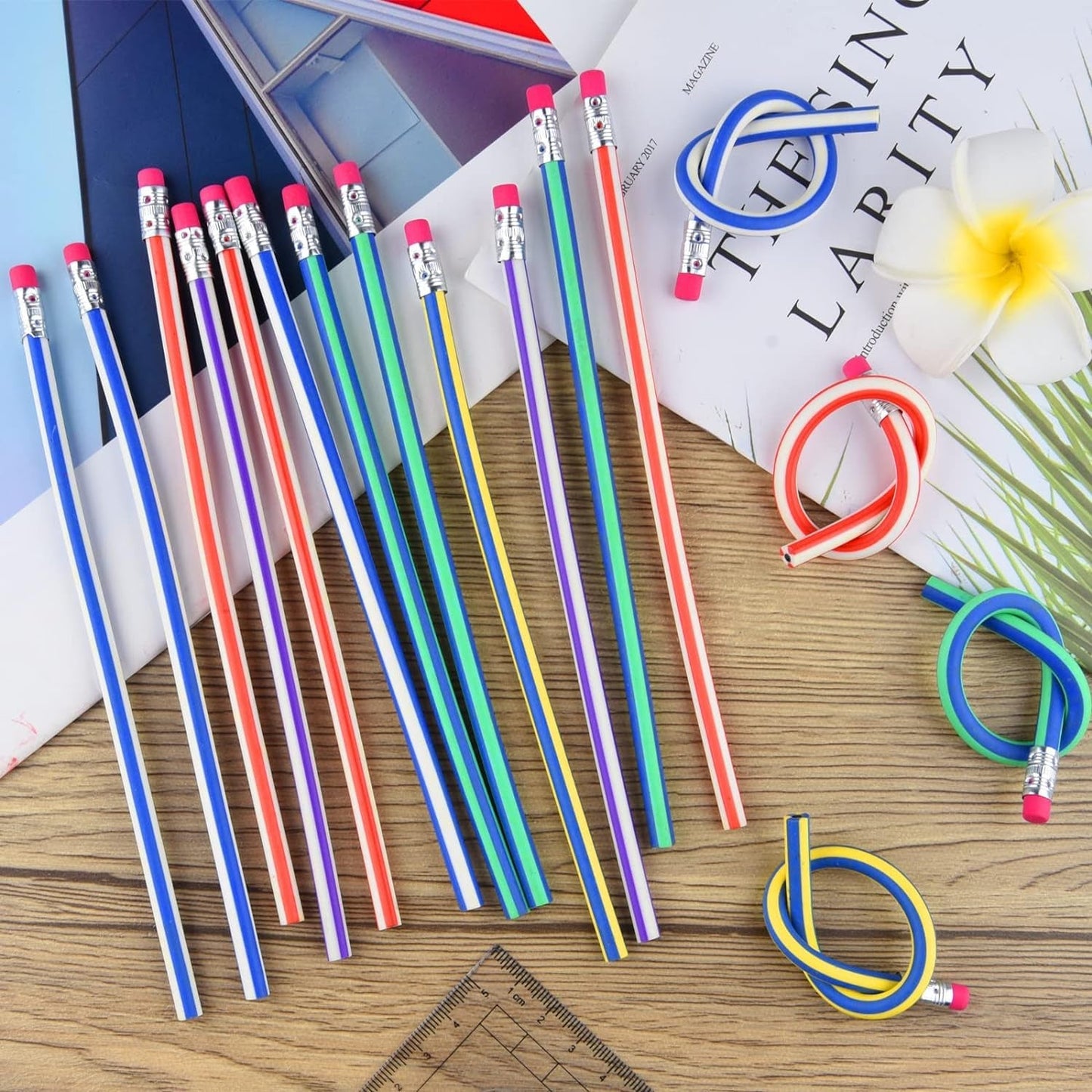 Swirl pencils on a desk with a notebook & supplies