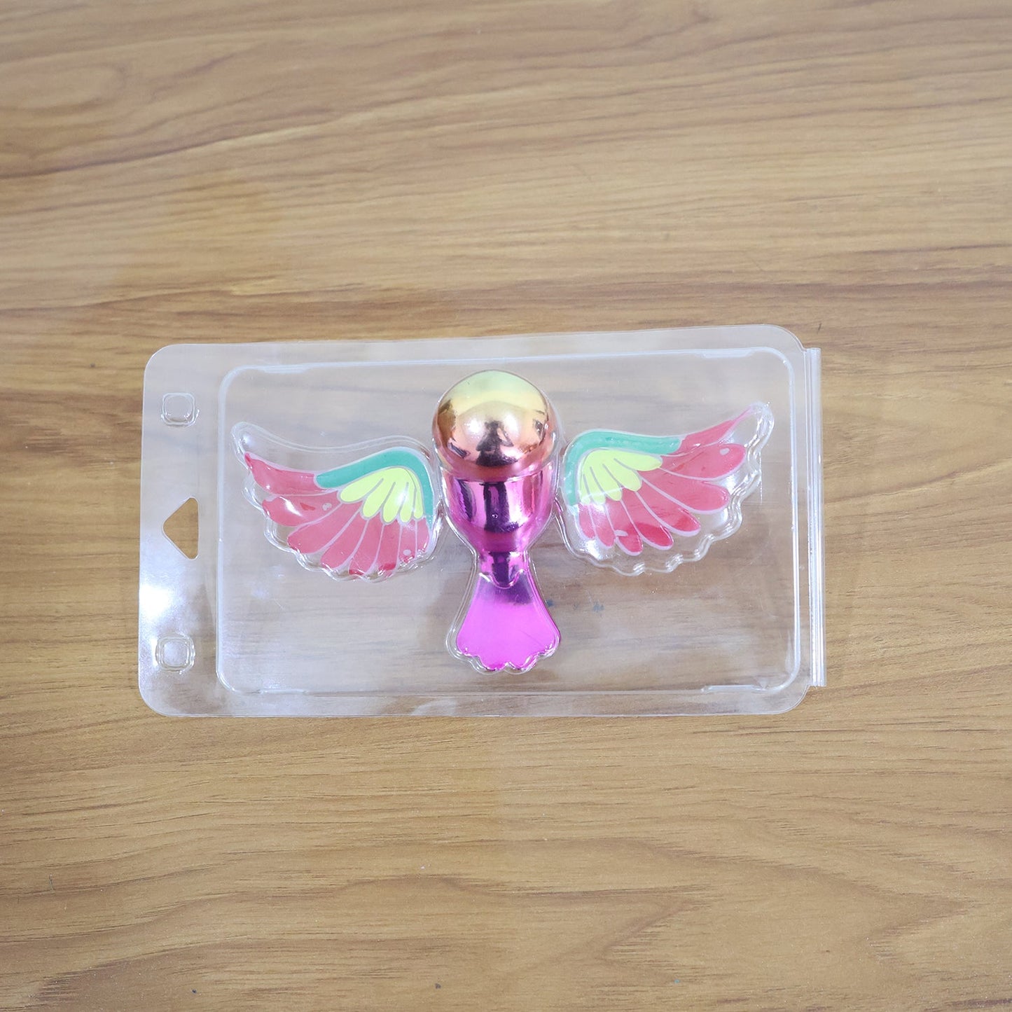Dashboard bird figurine with wings fluttering through wind activation