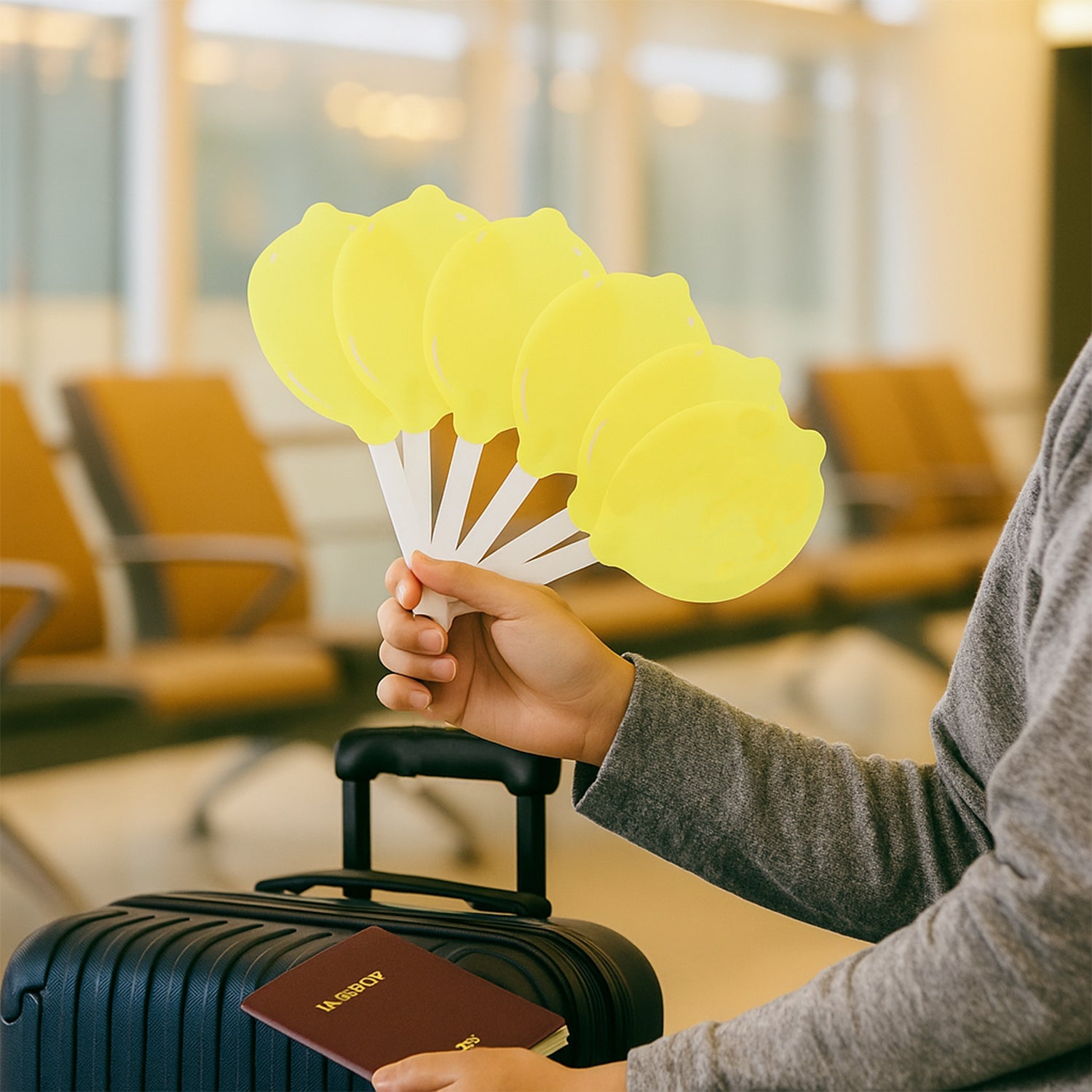 Multi-panel lemon-shaped hand fan fully open for personal cooling