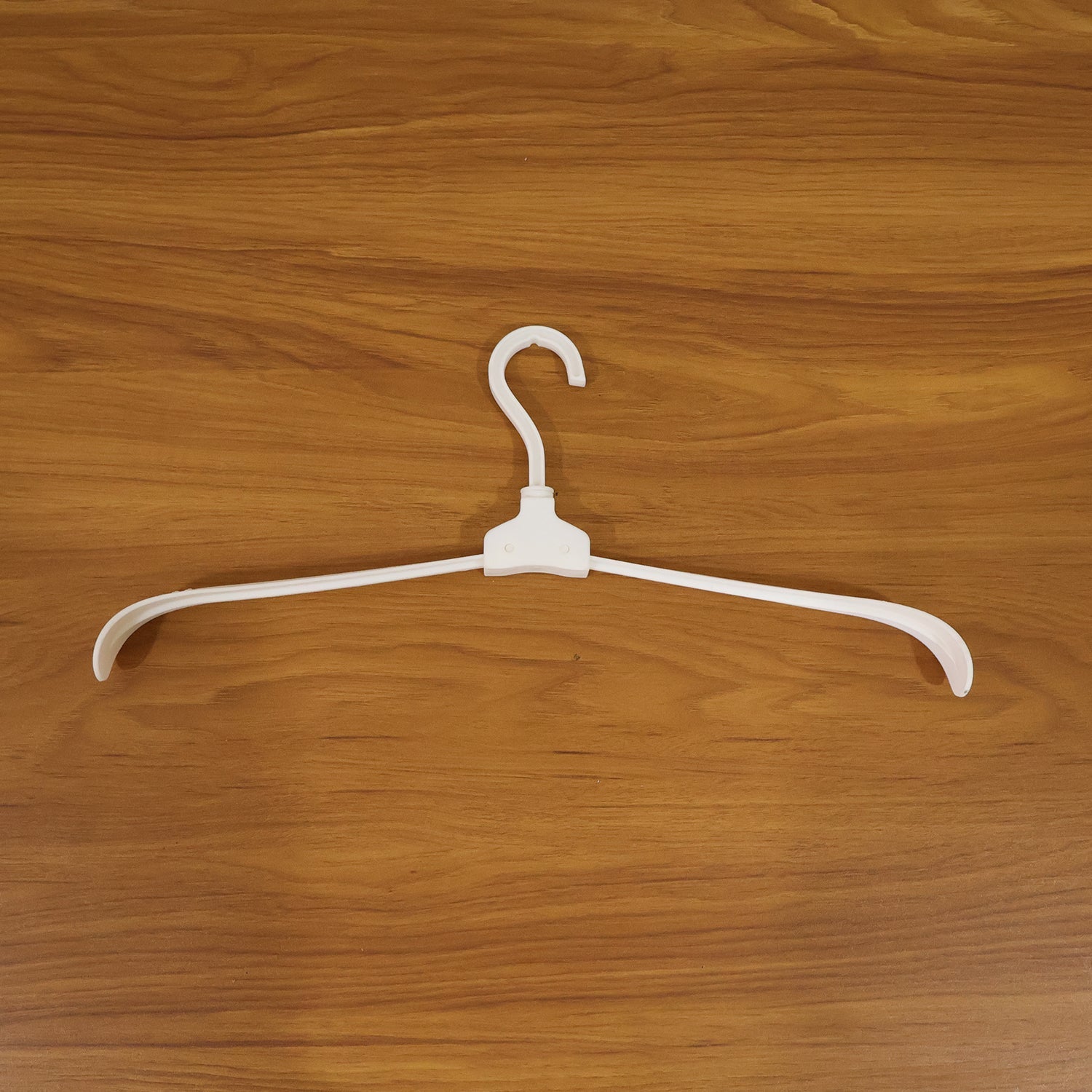 Plastic foldable garment hanger in use for organized closet